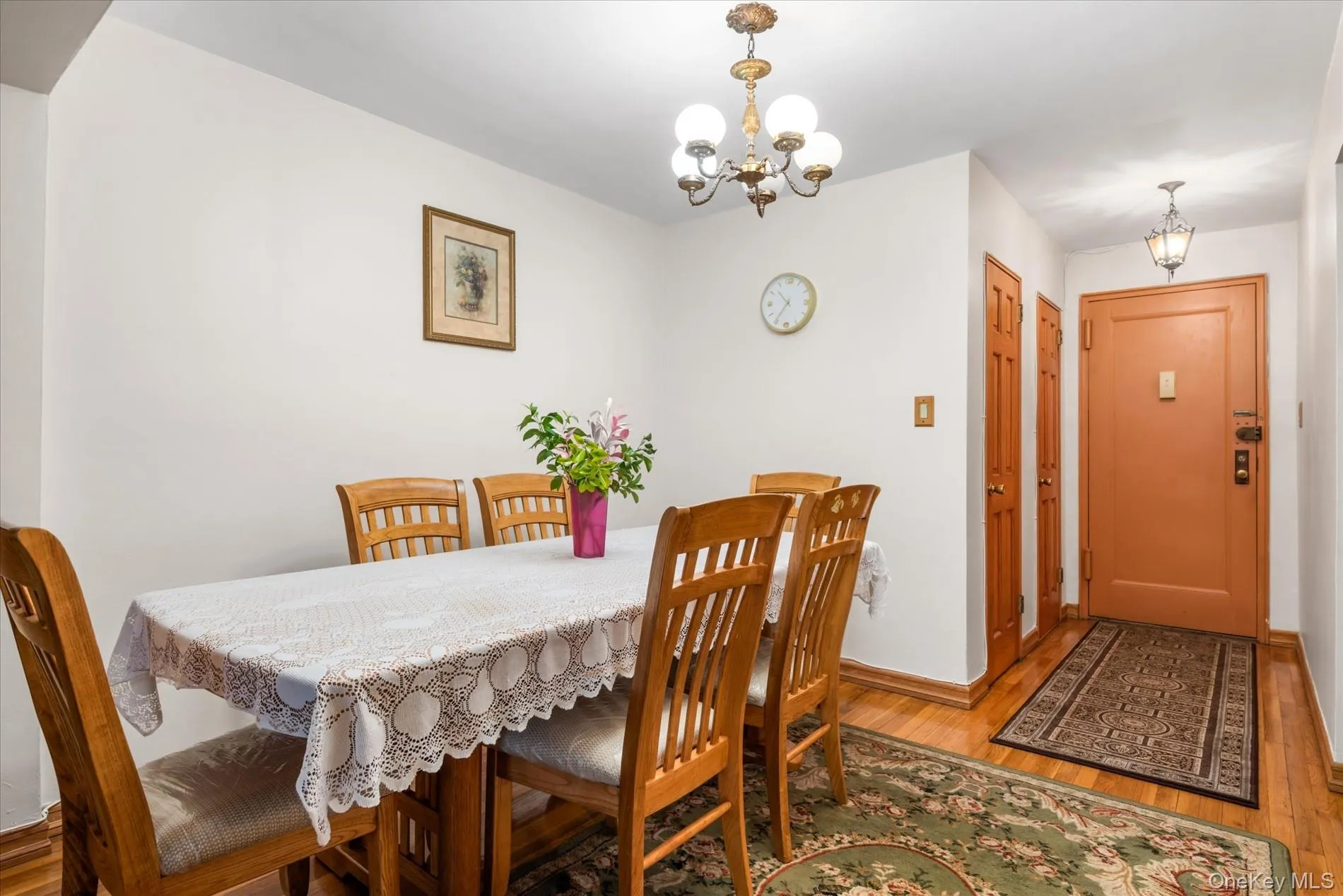 Dining area featuring a chandelier, light wood-style flooring, and baseboards Dining area featuring a chandelier, light wood-style flooring, and baseboards