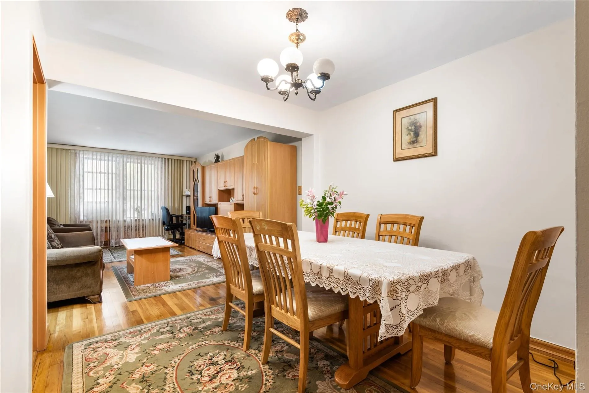 Dining room featuring a chandelier and light wood-type flooring Dining room featuring a chandelier and light wood-type flooring