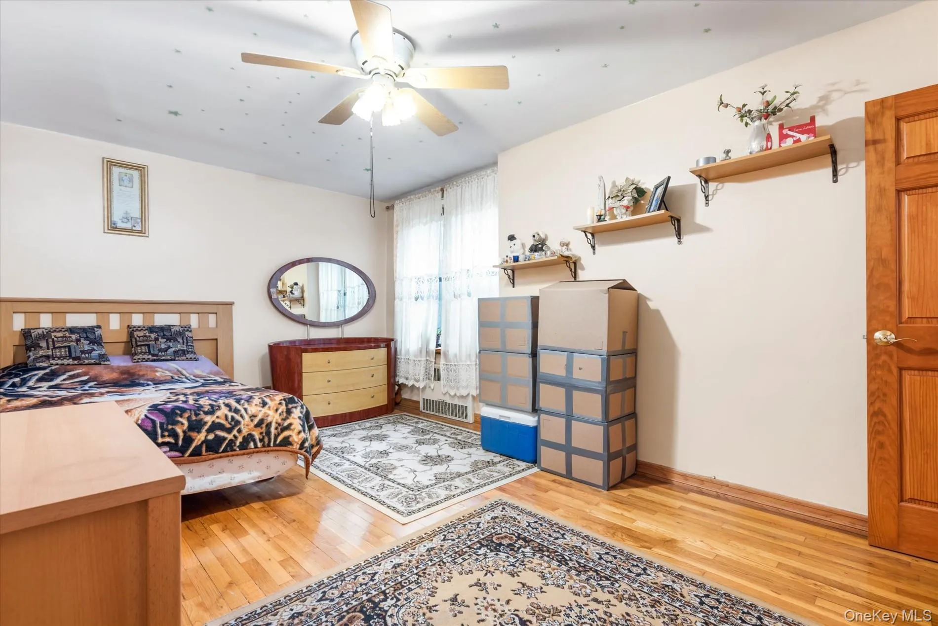 Bedroom featuring light wood-style floors and baseboards Bedroom featuring light wood-style floors and baseboards