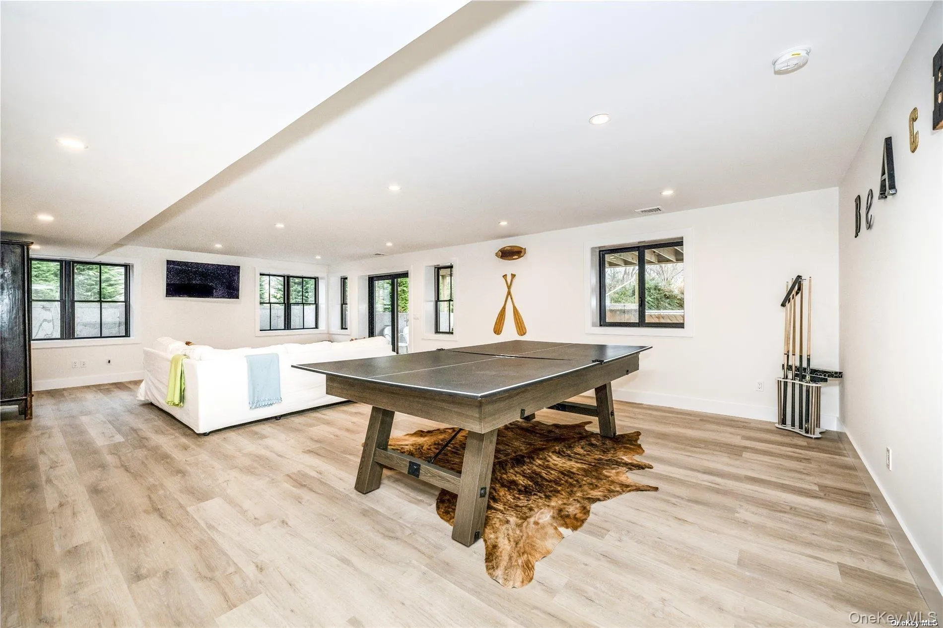 Recreation room with recessed lighting, light wood-type flooring, and baseboards Recreation room with recessed lighting, light wood-type flooring, and baseboards