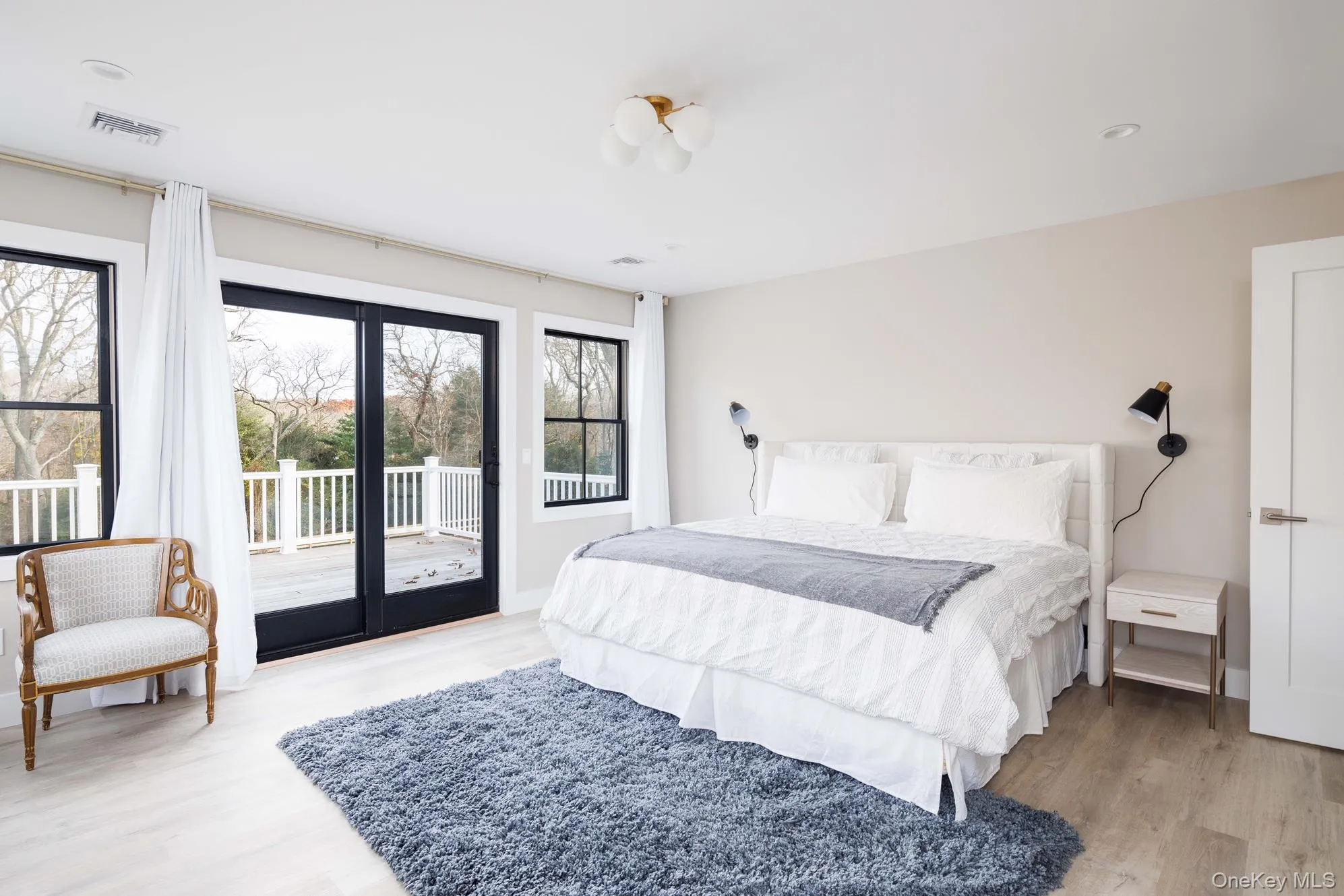 Bedroom with access to outside and light wood-style floors Bedroom with access to outside and light wood-style floors
