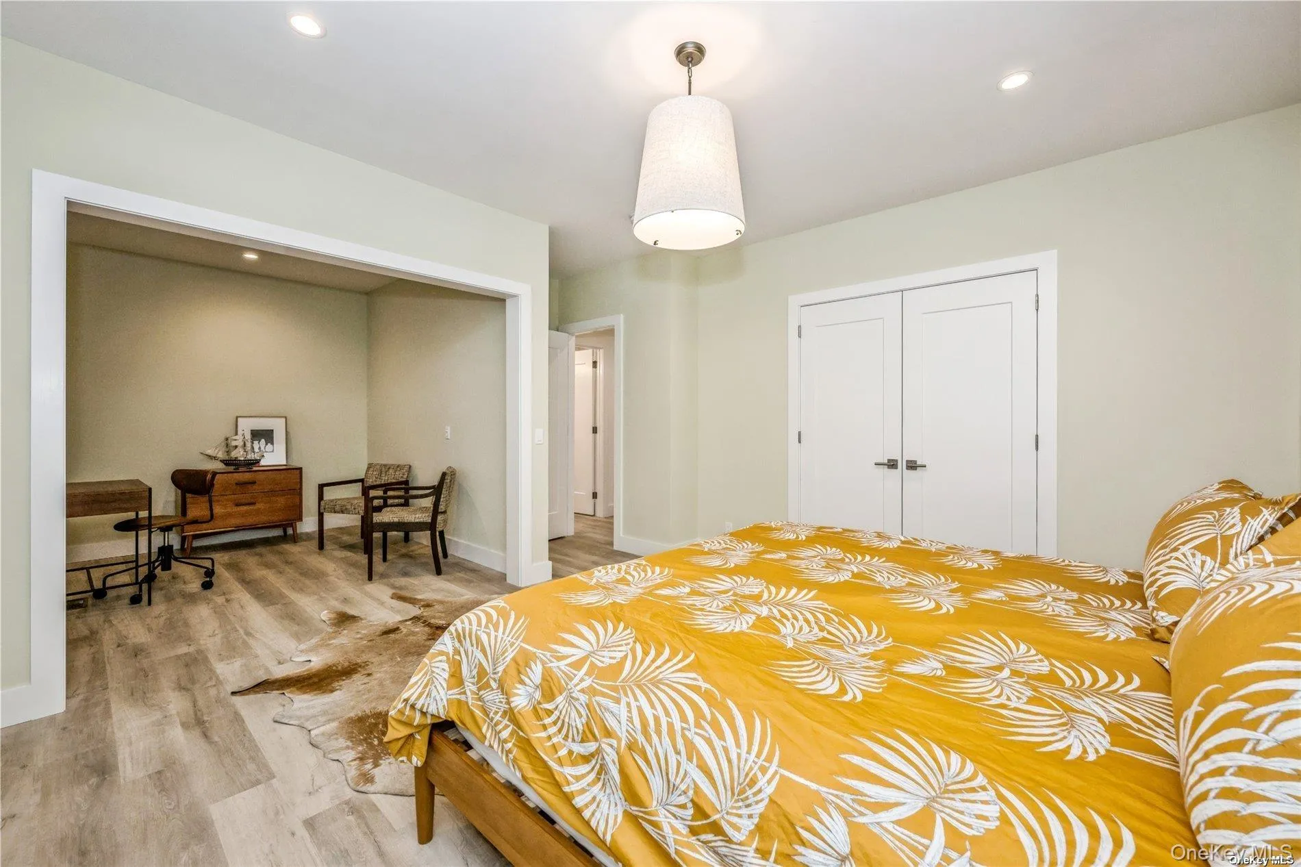 Bedroom featuring light wood finished floors, a closet, a desk, recessed lighting, and baseboards Bedroom featuring light wood finished floors, a closet, a desk, recessed lighting, and baseboards
