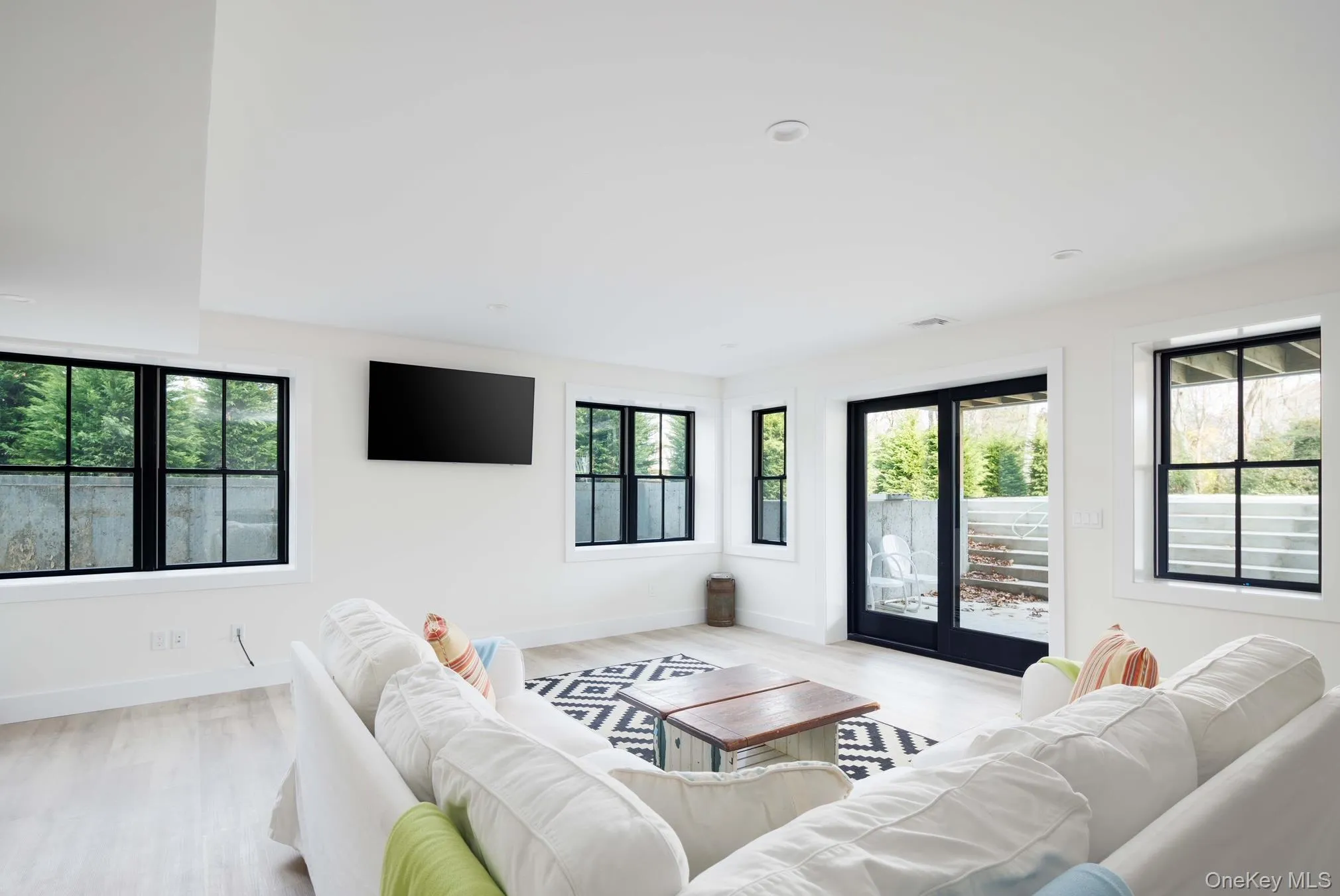 Living room with baseboards and light wood-style flooring Living room with baseboards and light wood-style flooring