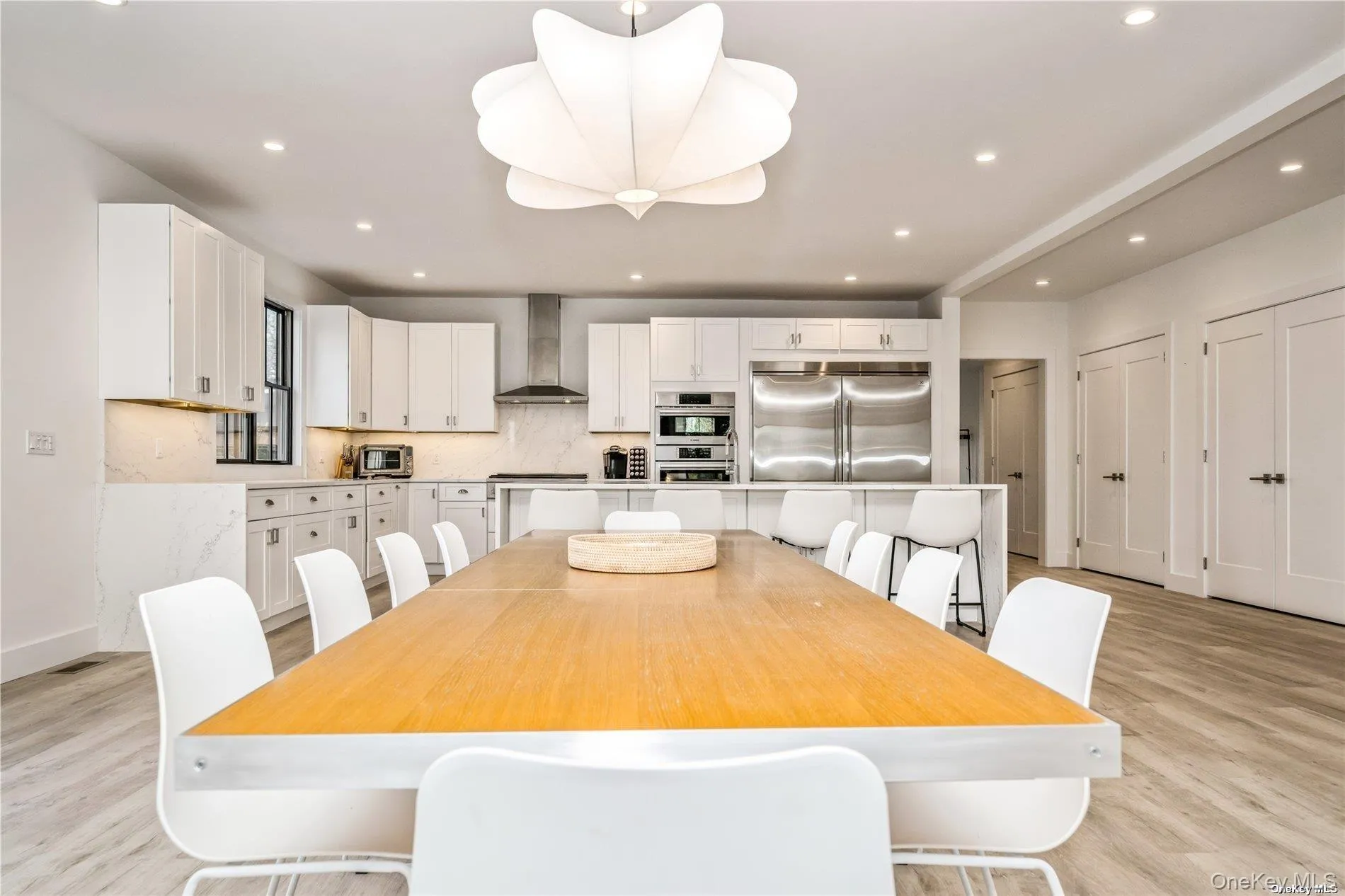 Dining space with light wood-style floors, recessed lighting, and baseboards Dining space with light wood-style floors, recessed lighting, and baseboards