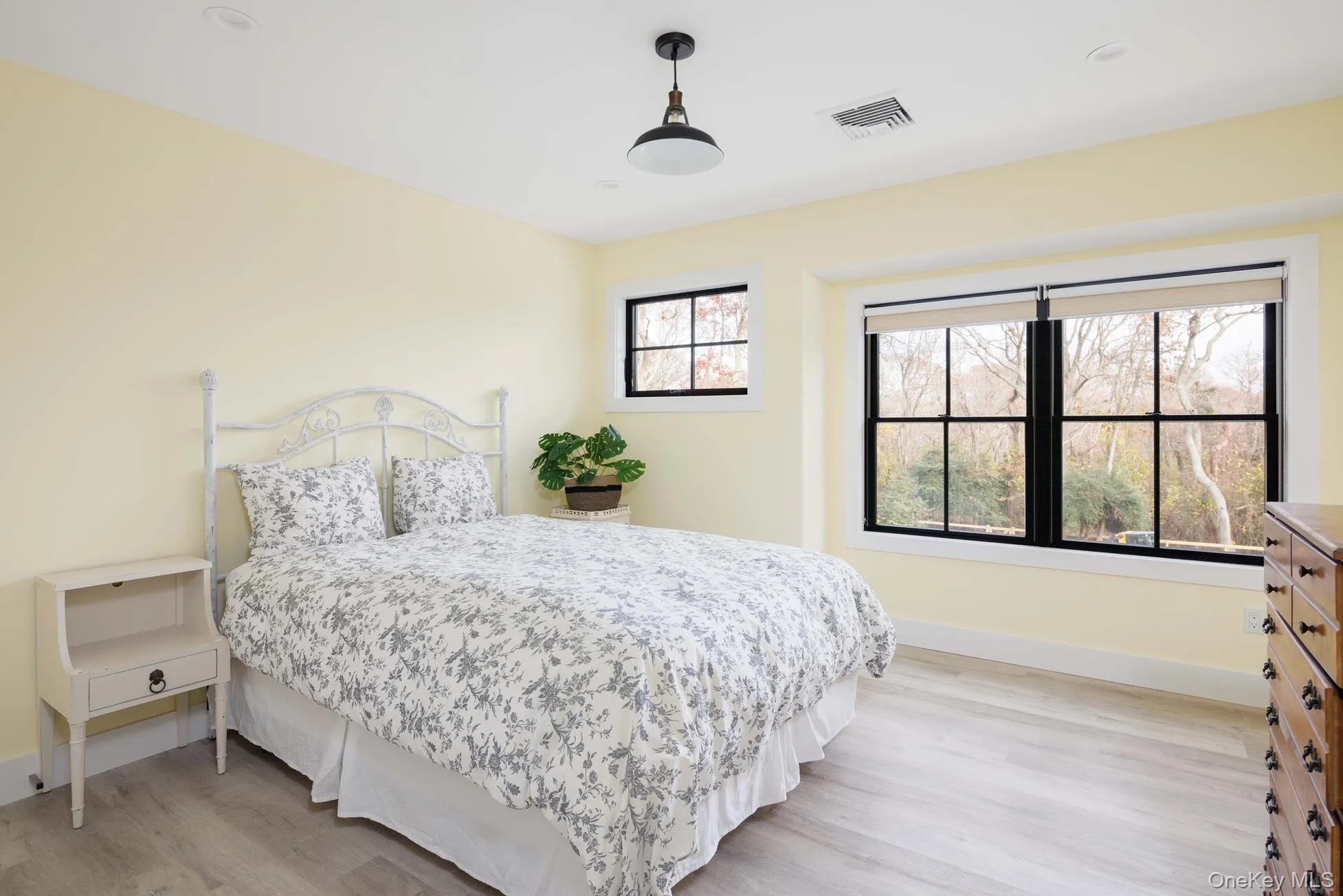 Bedroom with light wood finished floors and baseboards Bedroom with light wood finished floors and baseboards