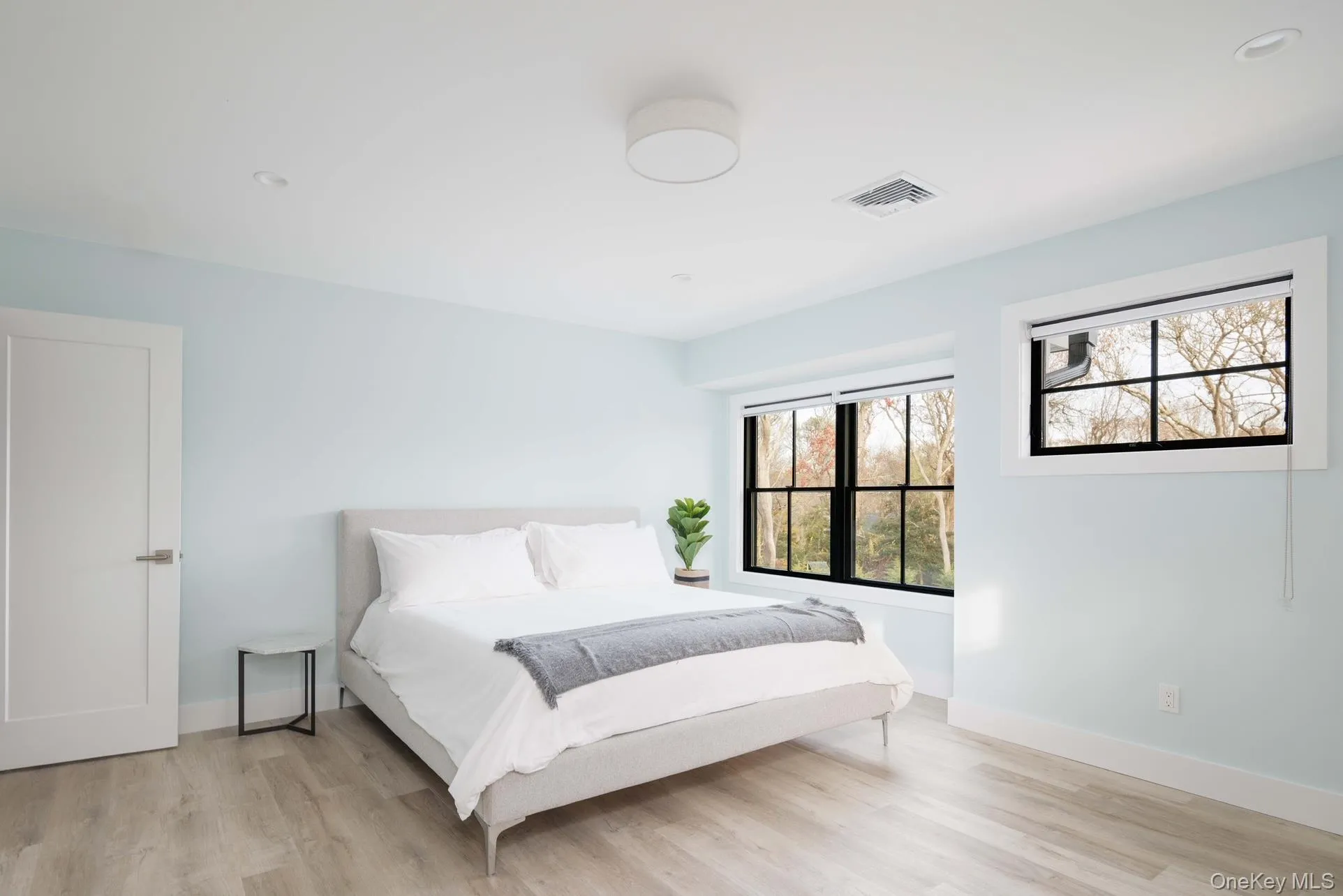 Bedroom featuring light wood-style floors, baseboards, and recessed lighting Bedroom featuring light wood-style floors, baseboards, and recessed lighting