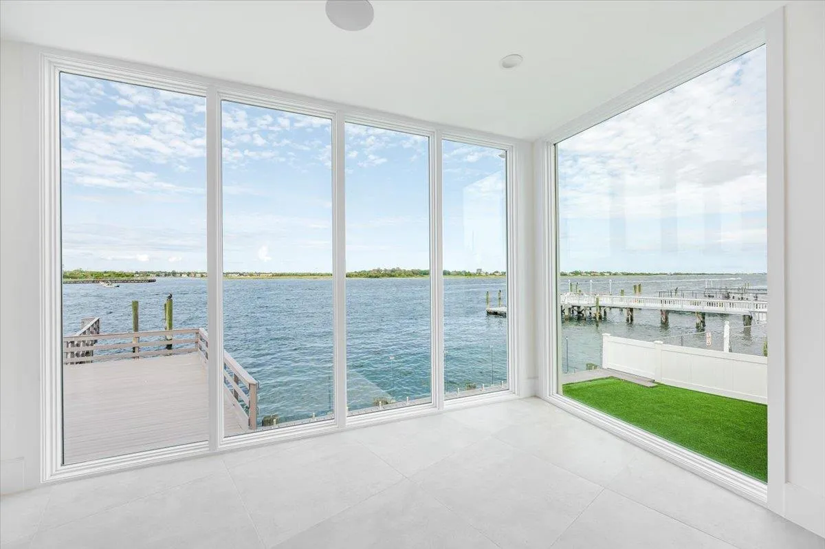 Unfurnished sunroom featuring a water view Unfurnished sunroom featuring a water view