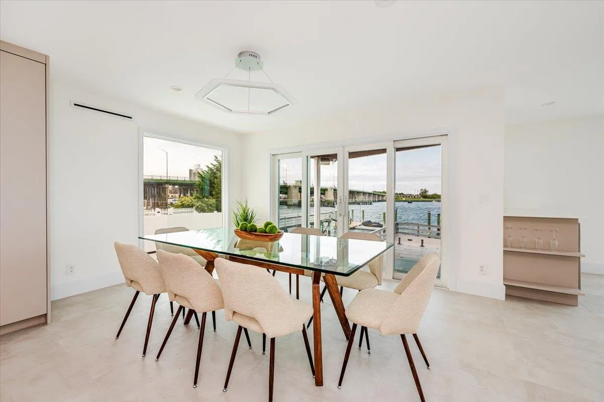 Dining space featuring plenty of natural light, a water view, and baseboards Dining space featuring plenty of natural light, a water view, and baseboards