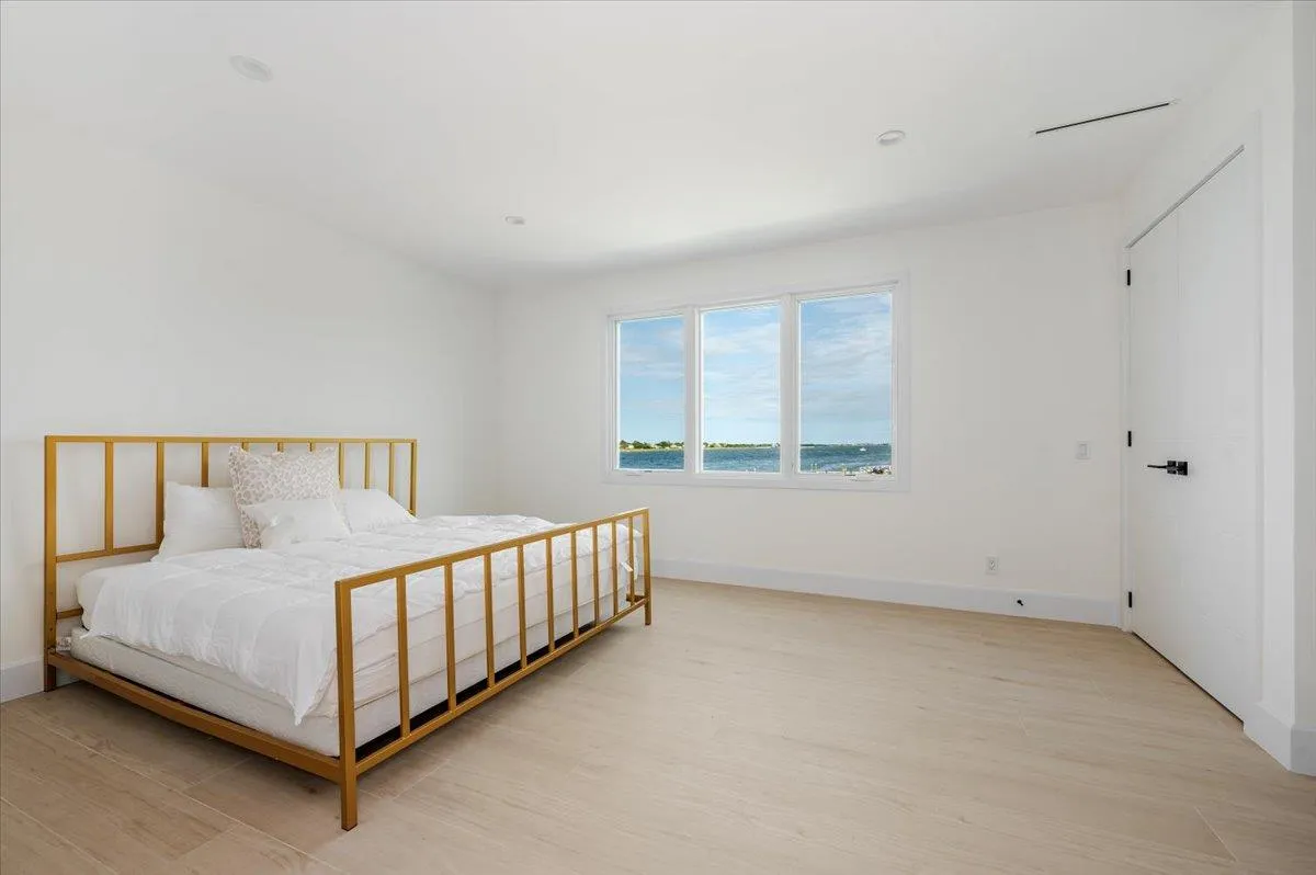 Bedroom with light wood-style flooring and baseboards Bedroom with light wood-style flooring and baseboards