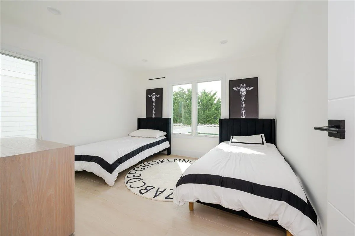 Bedroom featuring light wood-style flooring and baseboards Bedroom featuring light wood-style flooring and baseboards