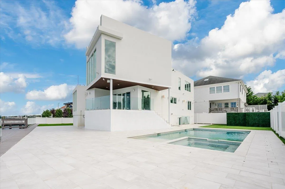 View of pool with an in-ground hot tub, fence, a patio, and stairway View of pool with an in-ground hot tub, fence, a patio, and stairway