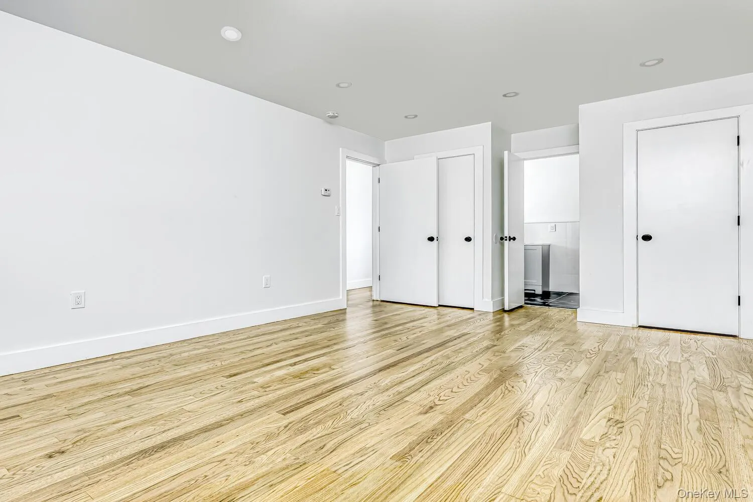 Unfurnished bedroom featuring light wood finished floors, baseboards, and recessed lighting Unfurnished bedroom featuring light wood finished floors, baseboards, and recessed lighting