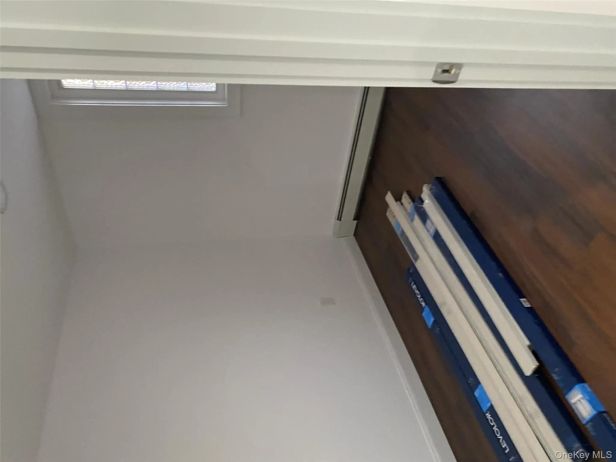 Spare room featuring a baseboard heating unit, dark wood-style floors, and baseboards Spare room featuring a baseboard heating unit, dark wood-style floors, and baseboards