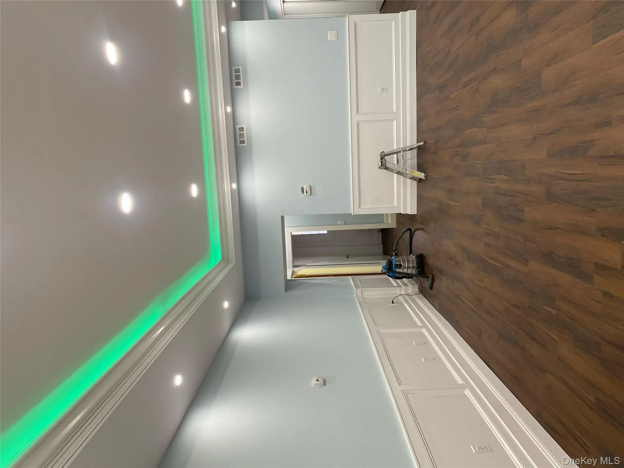 Unfurnished room featuring a decorative wall, wood finished floors, recessed lighting, and a wainscoted wall Unfurnished room featuring a decorative wall, wood finished floors, recessed lighting, and a wainscoted wall