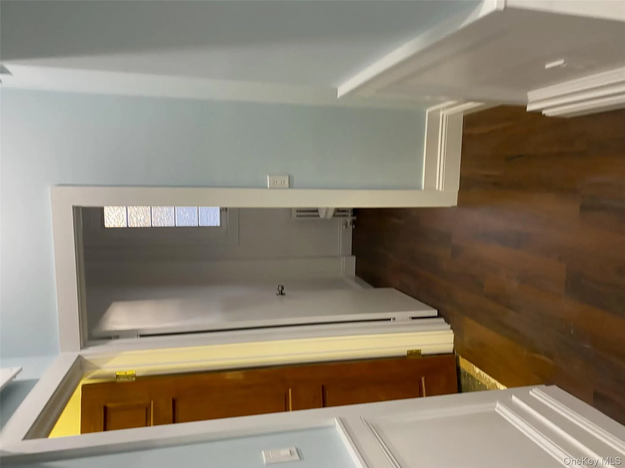 Hallway with dark wood-style floors, radiator heating unit, and baseboards Hallway with dark wood-style floors, radiator heating unit, and baseboards