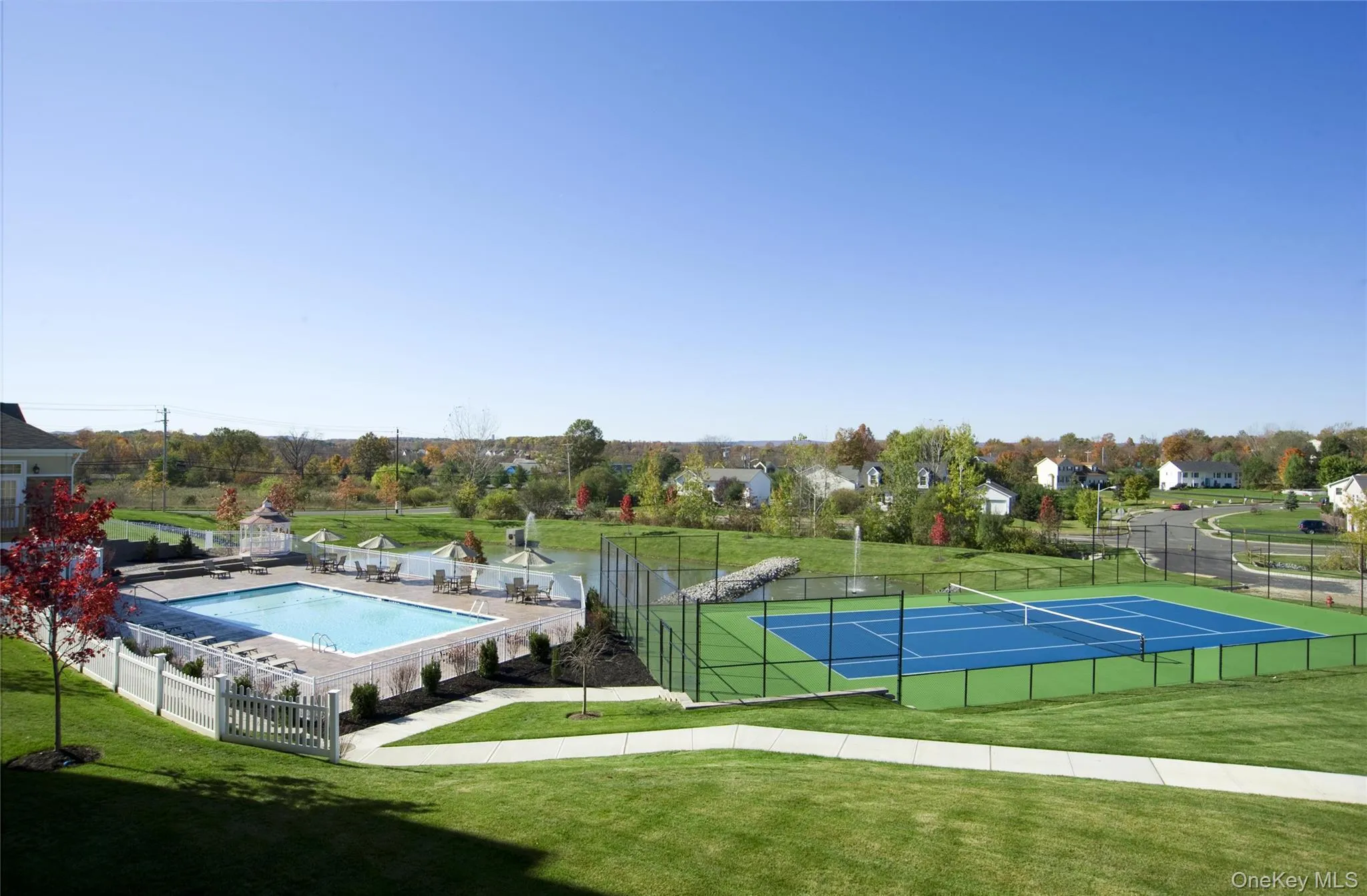 View of tennis court featuring a community pool View of tennis court featuring a community pool