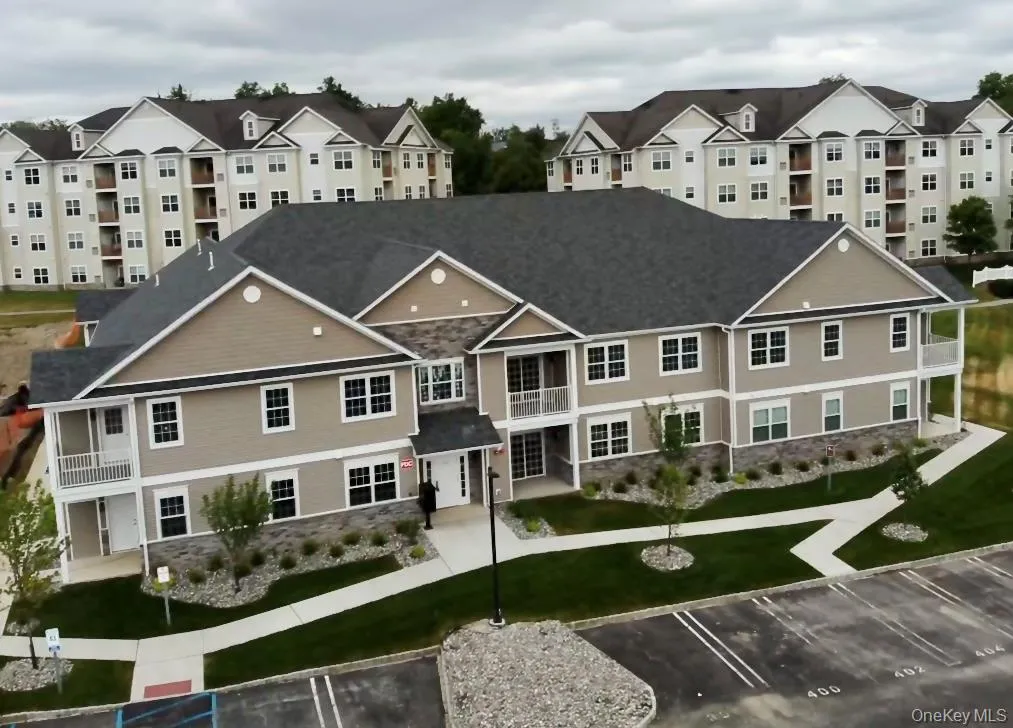 View of building exterior with uncovered parking View of building exterior with uncovered parking