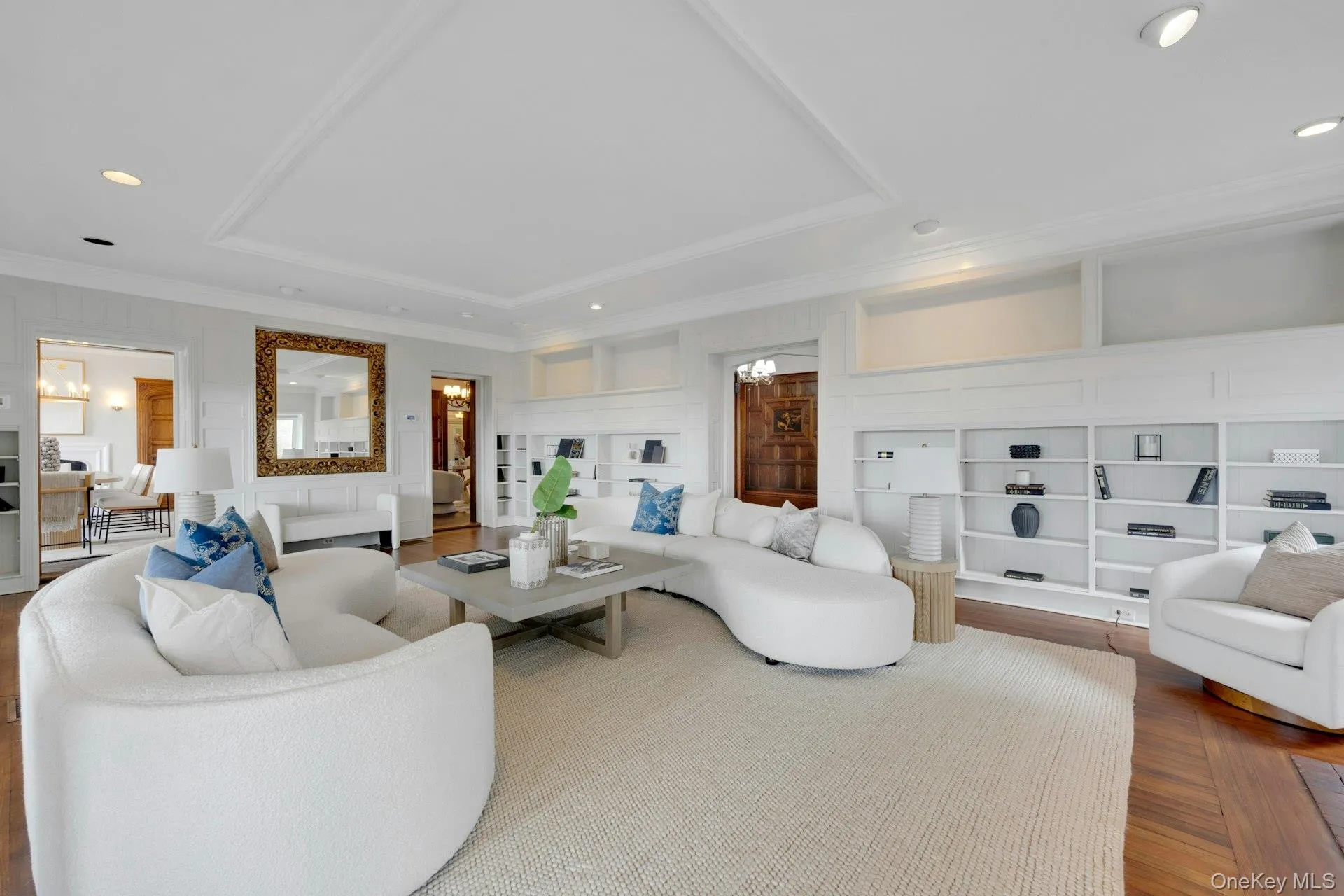 Living area featuring a raised ceiling, ornamental molding, a decorative wall, and Hudson River views Living area featuring a raised ceiling, ornamental molding, a decorative wall, and Hudson River views