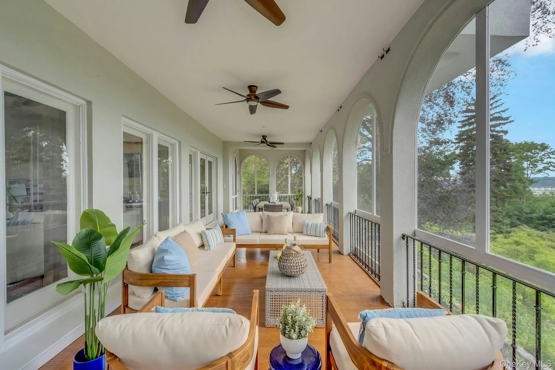 Sunroom with a ceiling fan, outdoor lounge area, and wood finished floors Sunroom with a ceiling fan, outdoor lounge area, and wood finished floors