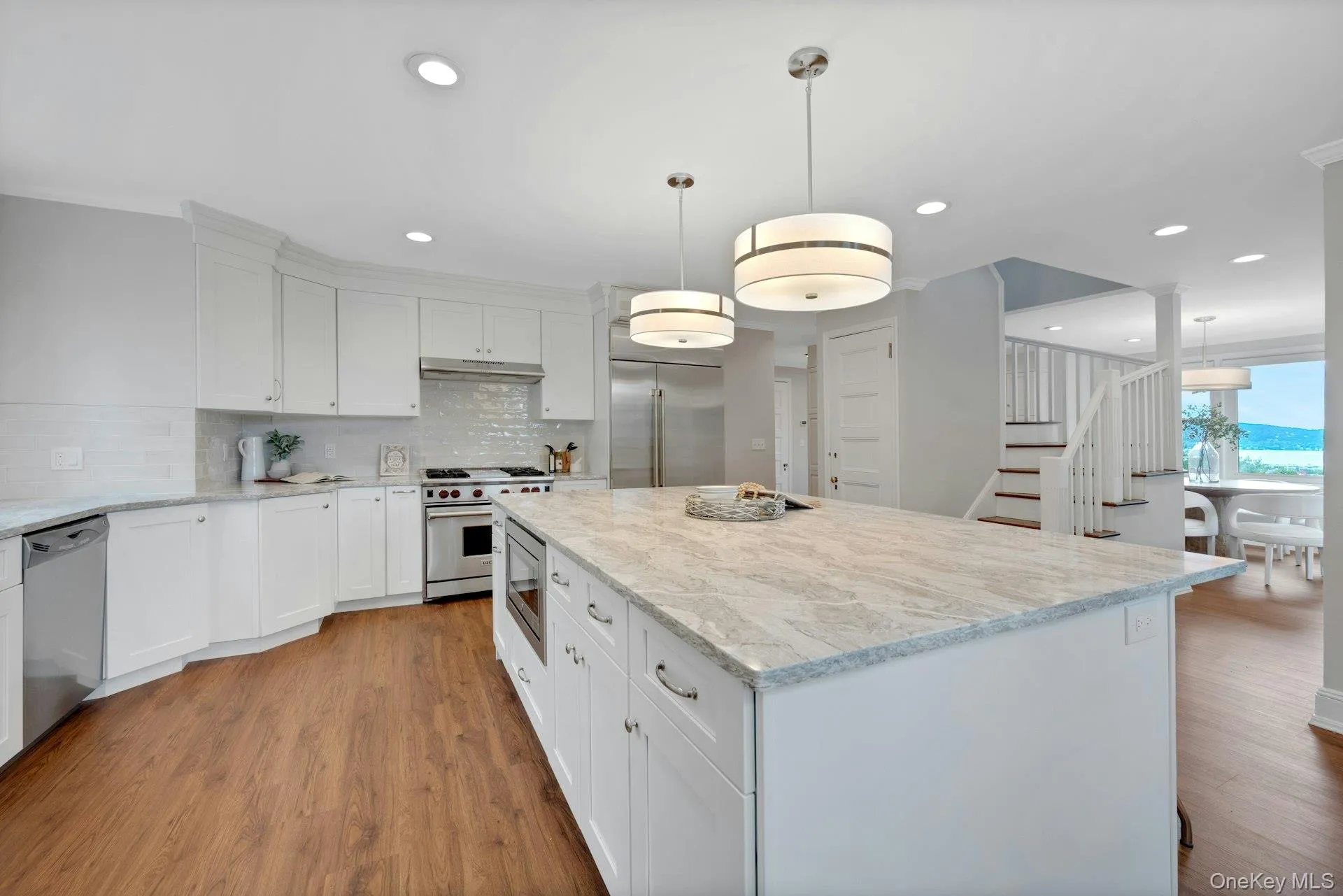 Kitchen with built in appliances, under cabinet range hood, light wood-style flooring, decorative backsplash, and recessed lighting and River views Kitchen with built in appliances, under cabinet range hood, light wood-style flooring, decorative backsplash, and recessed lighting and River views