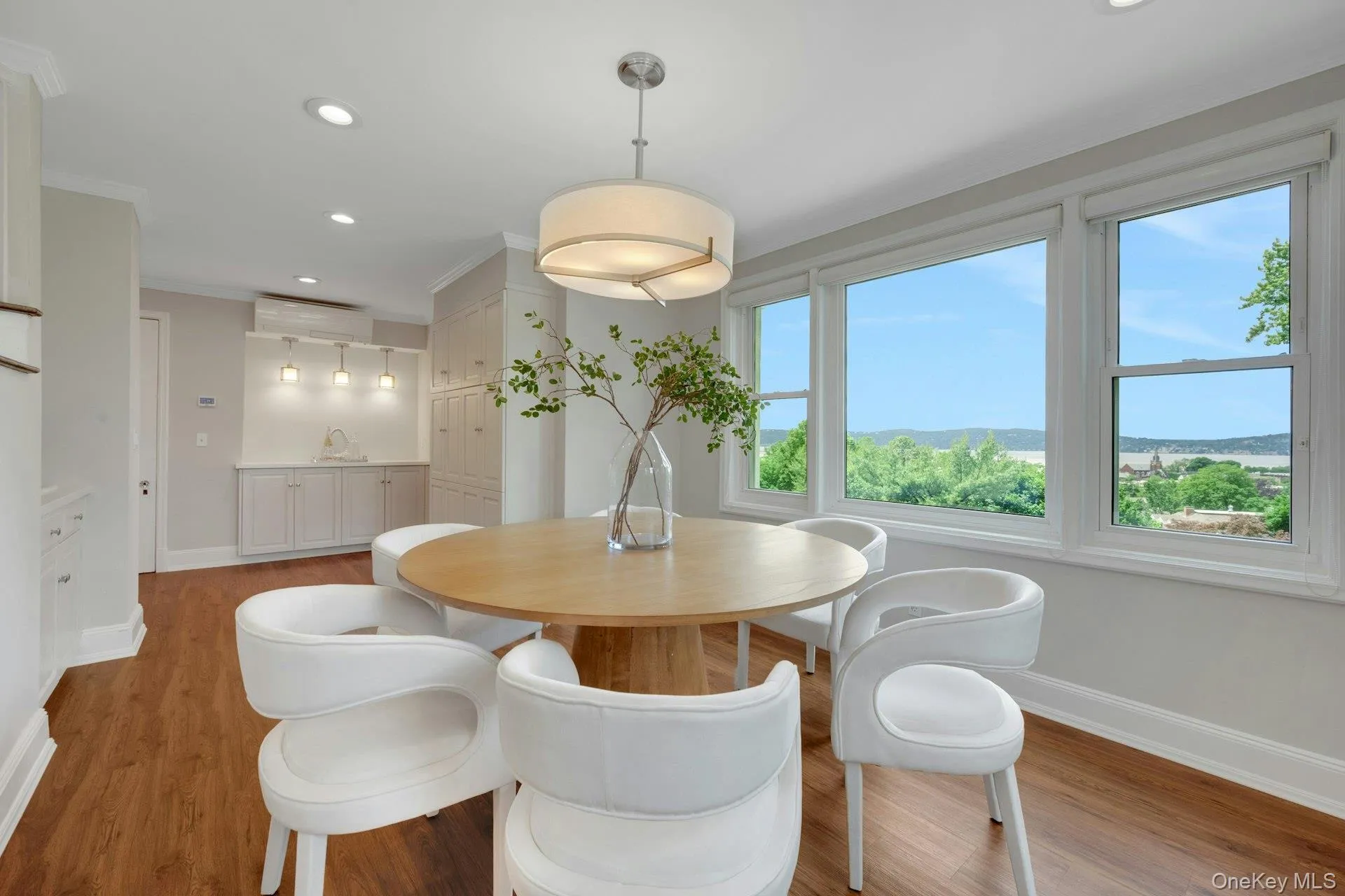 Dining space (connected to kitchen) with baseboards, wood finished floors, crown molding, amazing Hudson River views. Dining space (connected to kitchen) with baseboards, wood finished floors, crown molding, amazing Hudson River views.