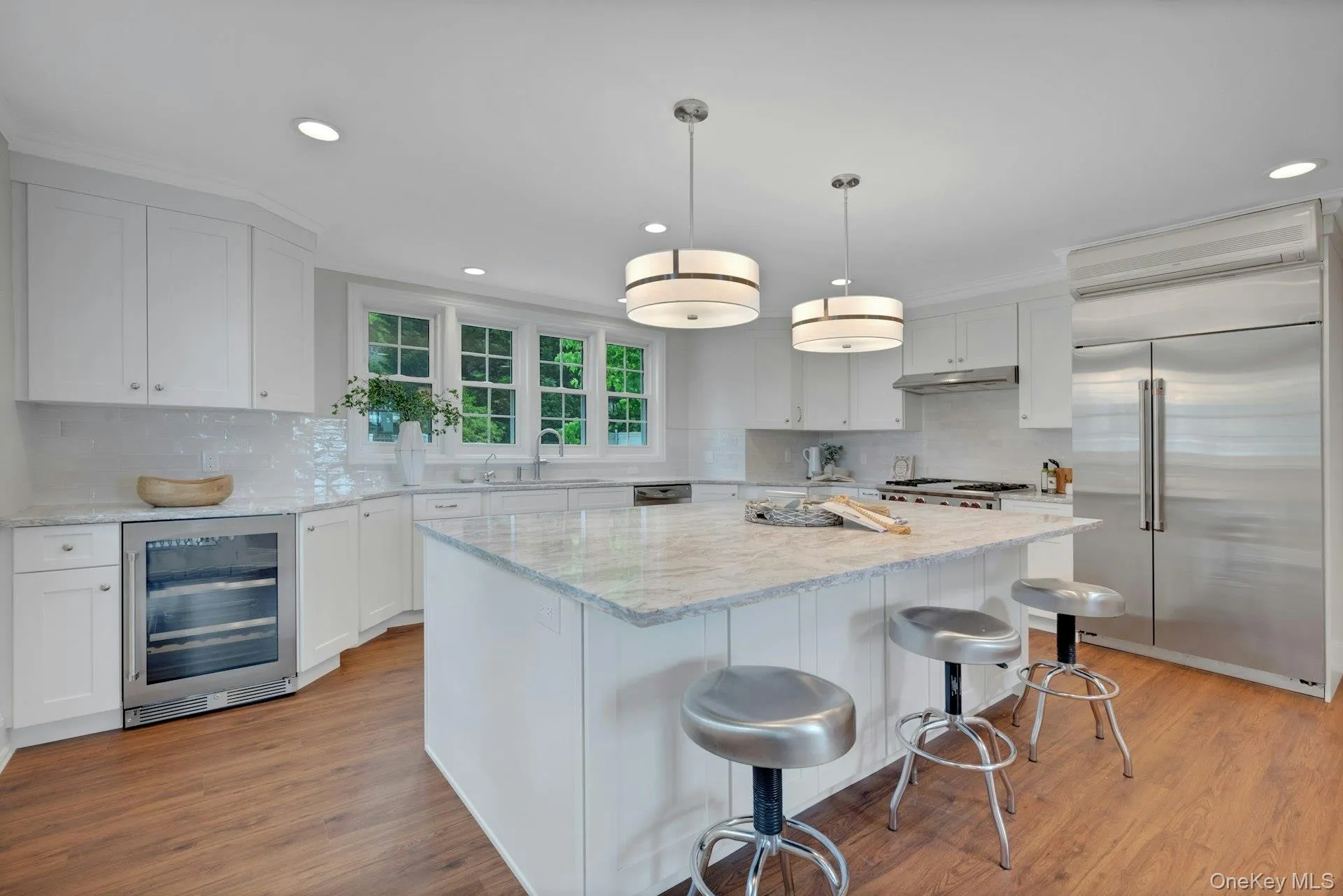 Brand new kitchen featuring beverage cooler, stainless steel appliances, a sink, recessed lighting, and tasteful backsplash Brand new kitchen featuring beverage cooler, stainless steel appliances, a sink, recessed lighting, and tasteful backsplash