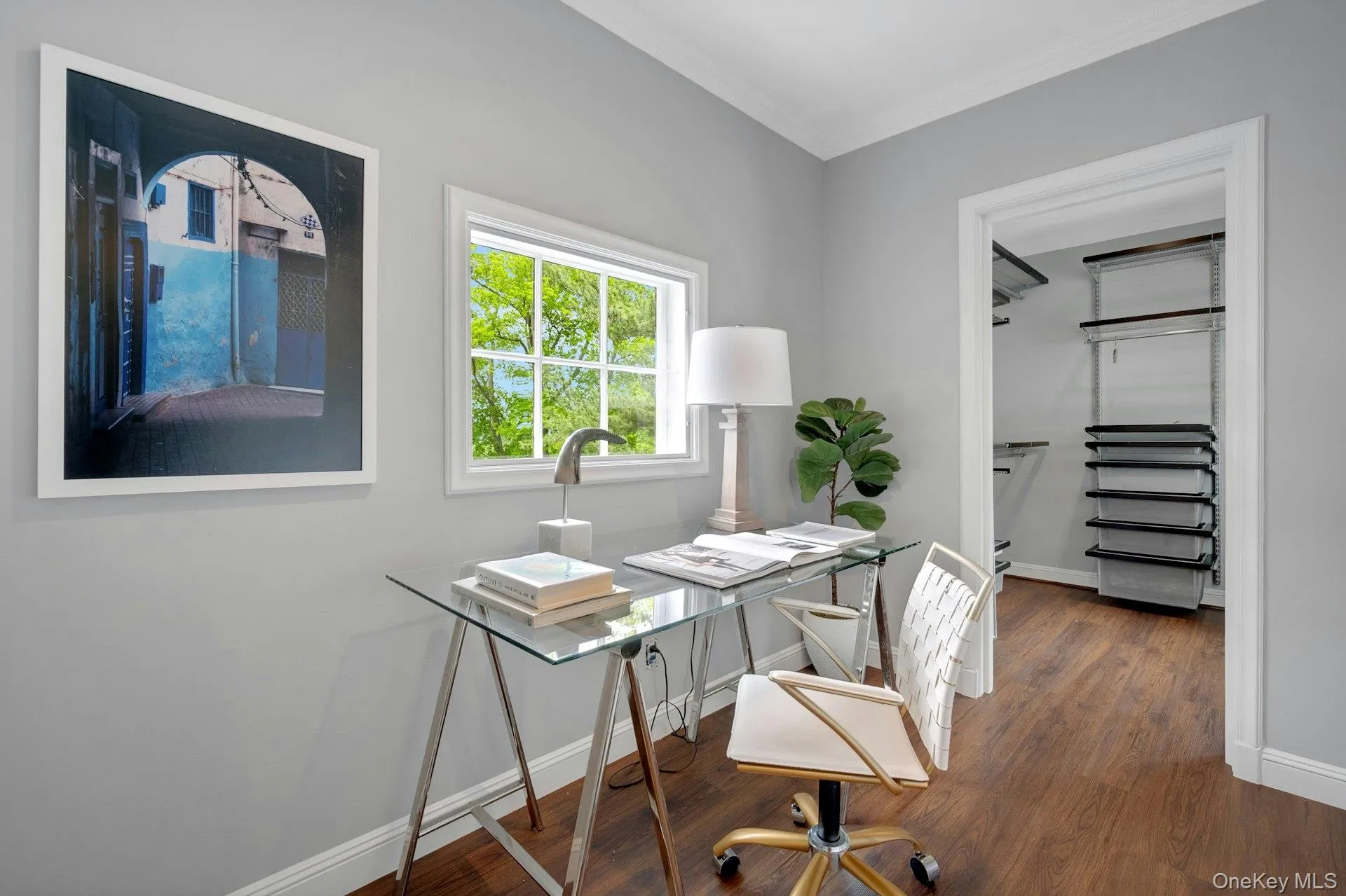 Office featuring ornamental molding, baseboards, and wood finished floors Office featuring ornamental molding, baseboards, and wood finished floors