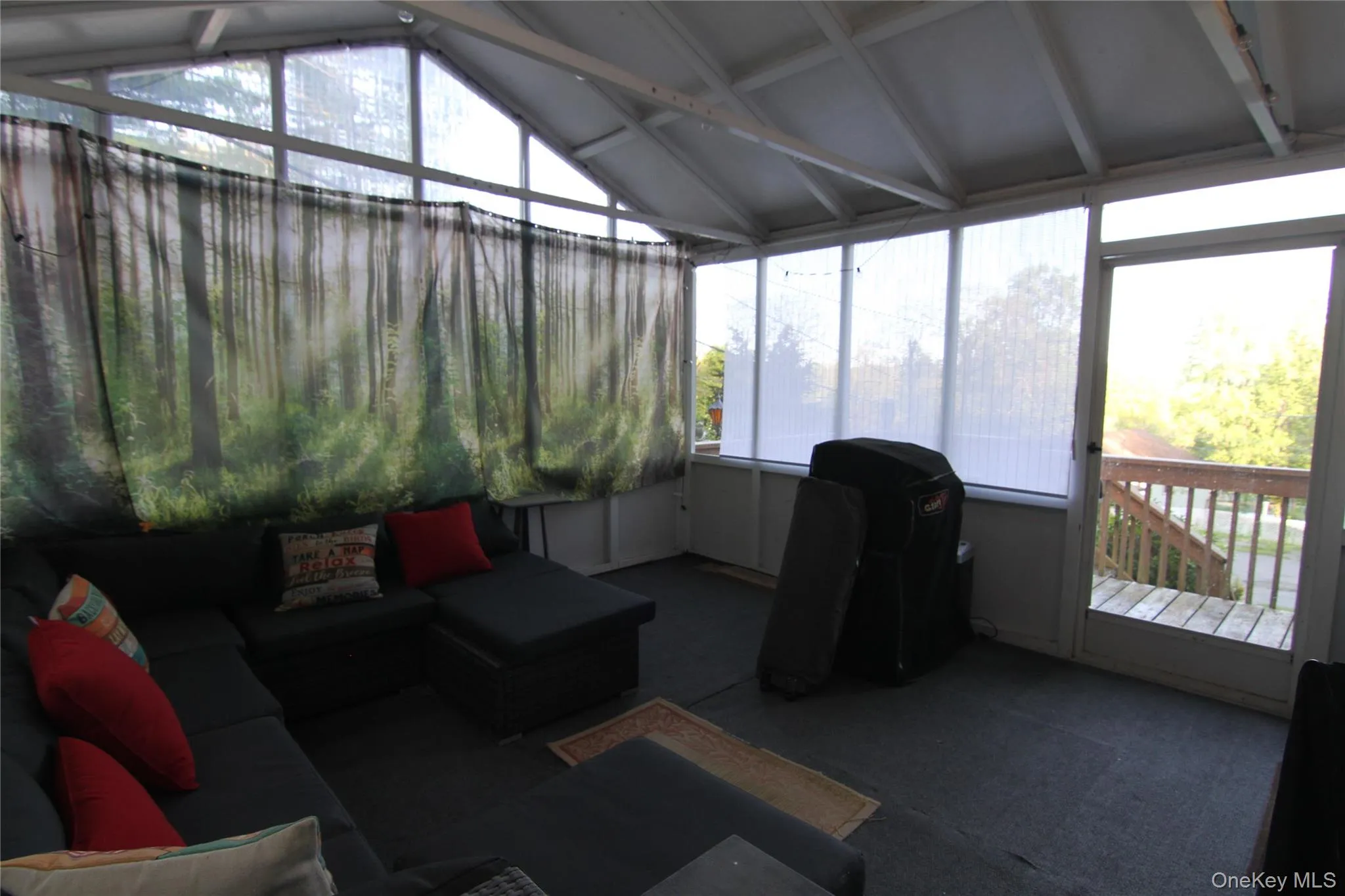 Sunroom / solarium with an outdoor hangout area and vaulted ceiling Sunroom / solarium with an outdoor hangout area and vaulted ceiling