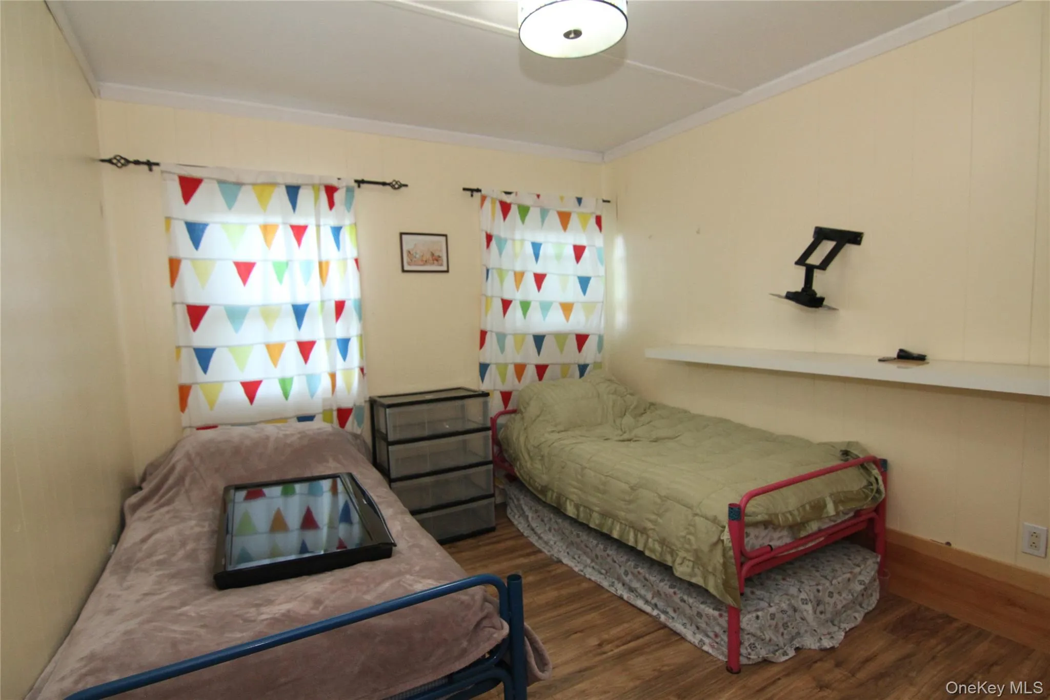 Bedroom with crown molding and wood finished floors Bedroom with crown molding and wood finished floors