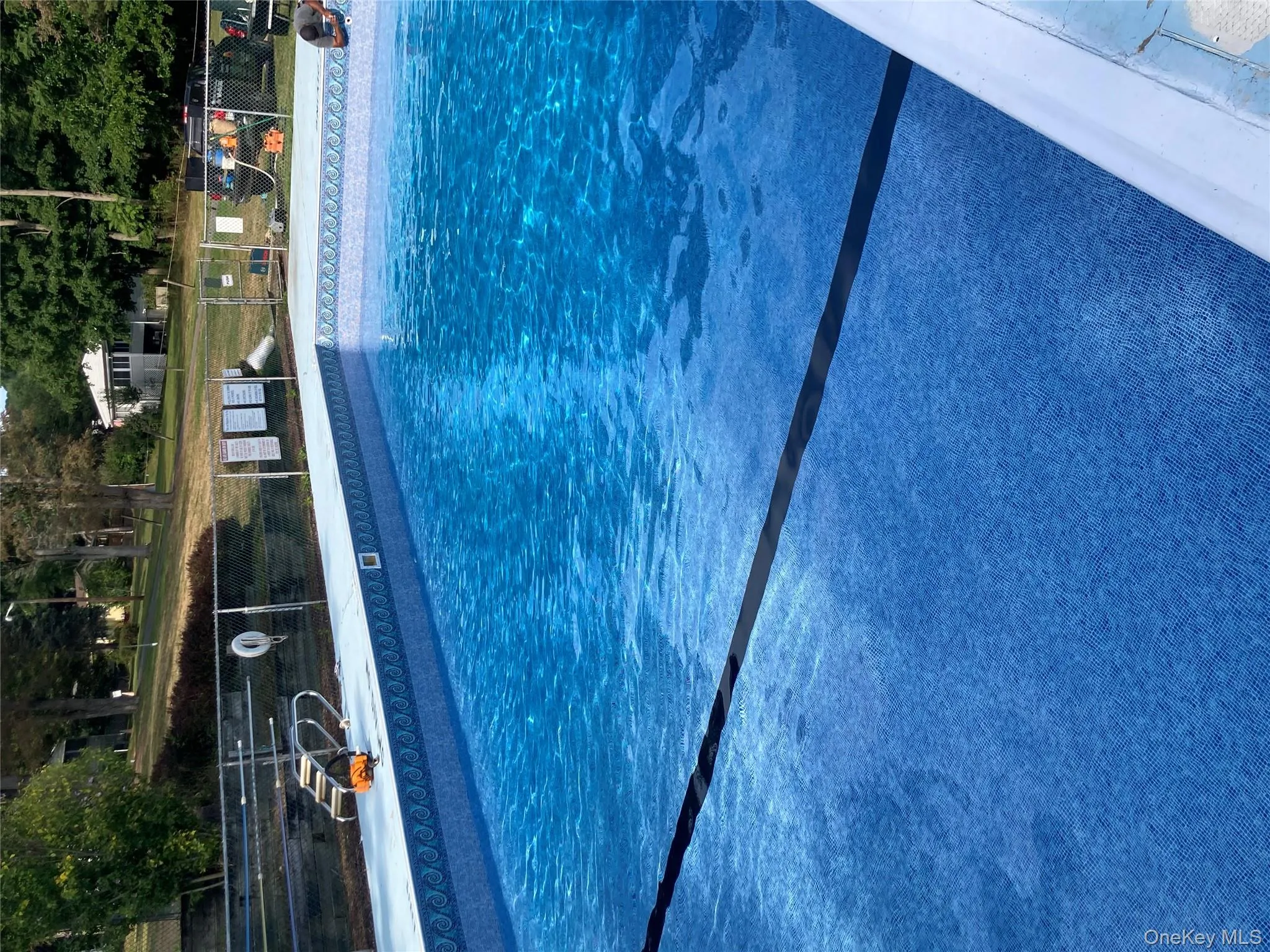 Community pool featuring view of wooded area Community pool featuring view of wooded area