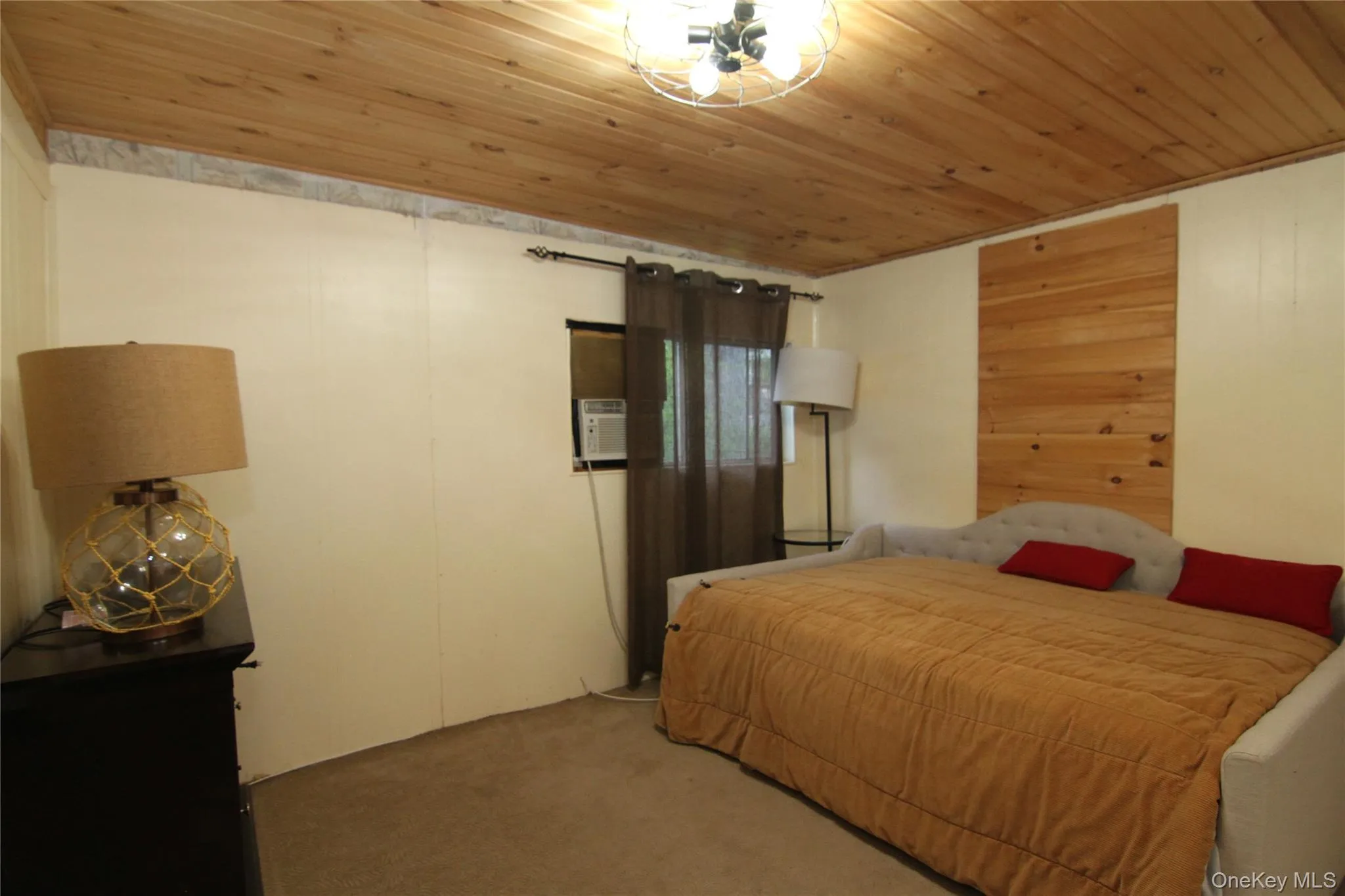 Carpeted bedroom with wooden ceiling Carpeted bedroom with wooden ceiling