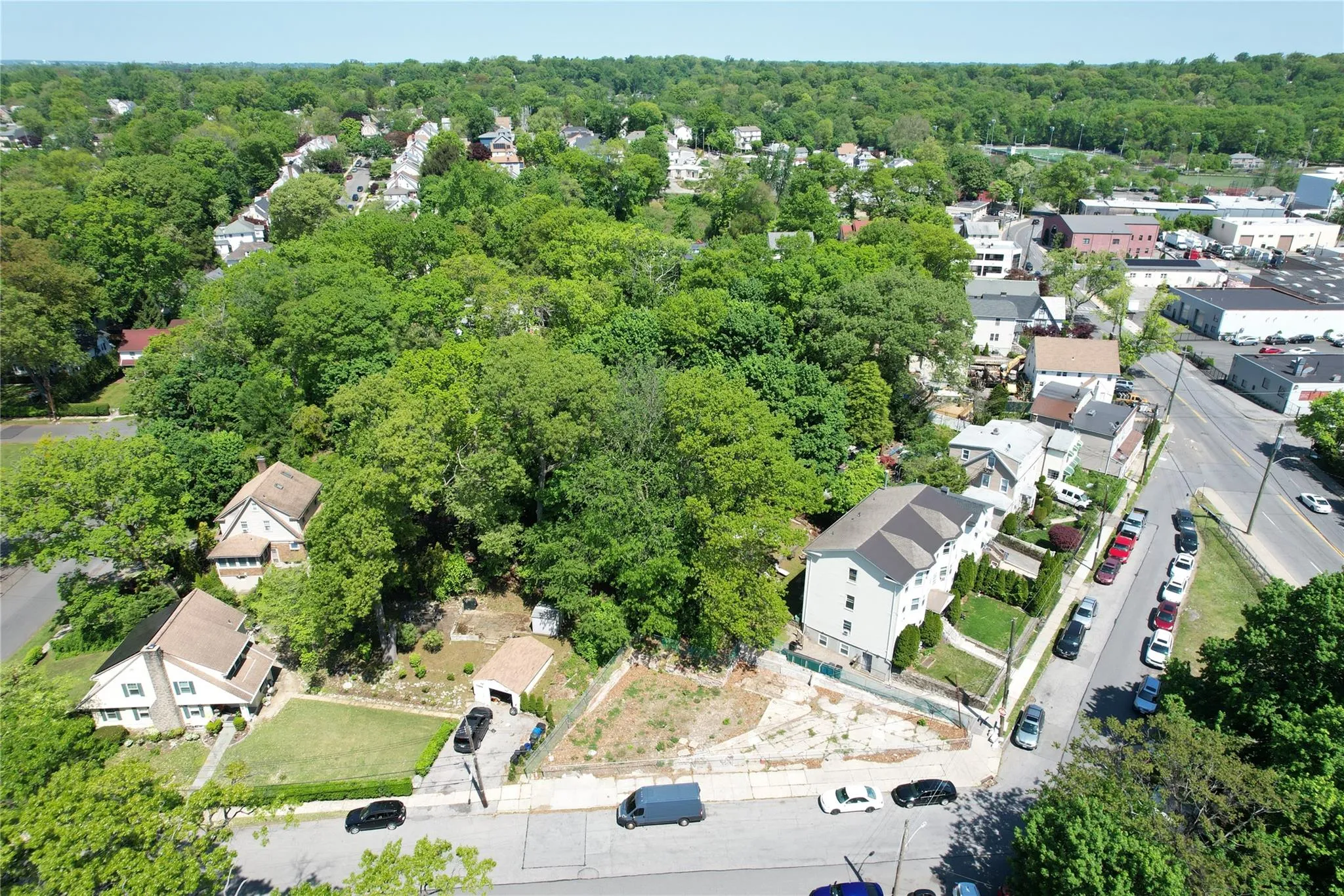 Aerial view of property's location with a forest and nearby suburban area Aerial view of property's location with a forest and nearby suburban area