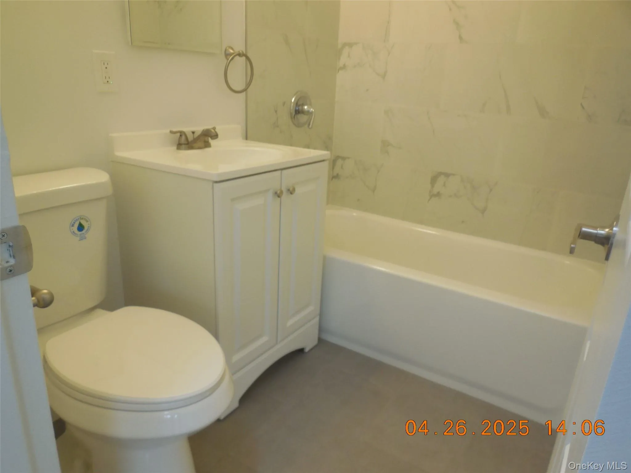 Full bathroom with toilet, vanity, and washtub / shower combination Full bathroom with toilet, vanity, and washtub / shower combination