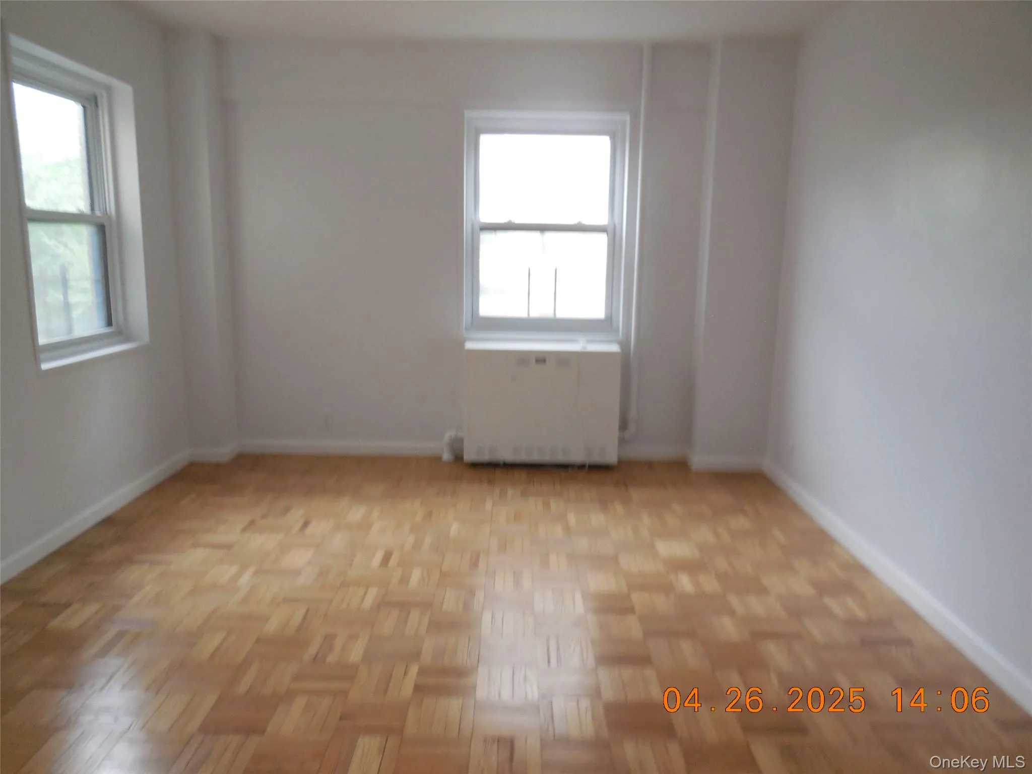 Spare room with radiator and baseboards Spare room with radiator and baseboards