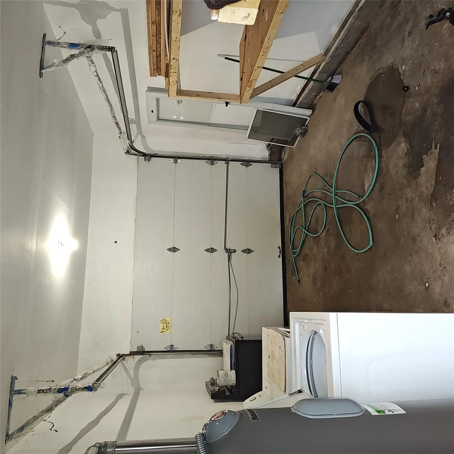 Garage with water heater and washing machine and dryer Garage with water heater and washing machine and dryer