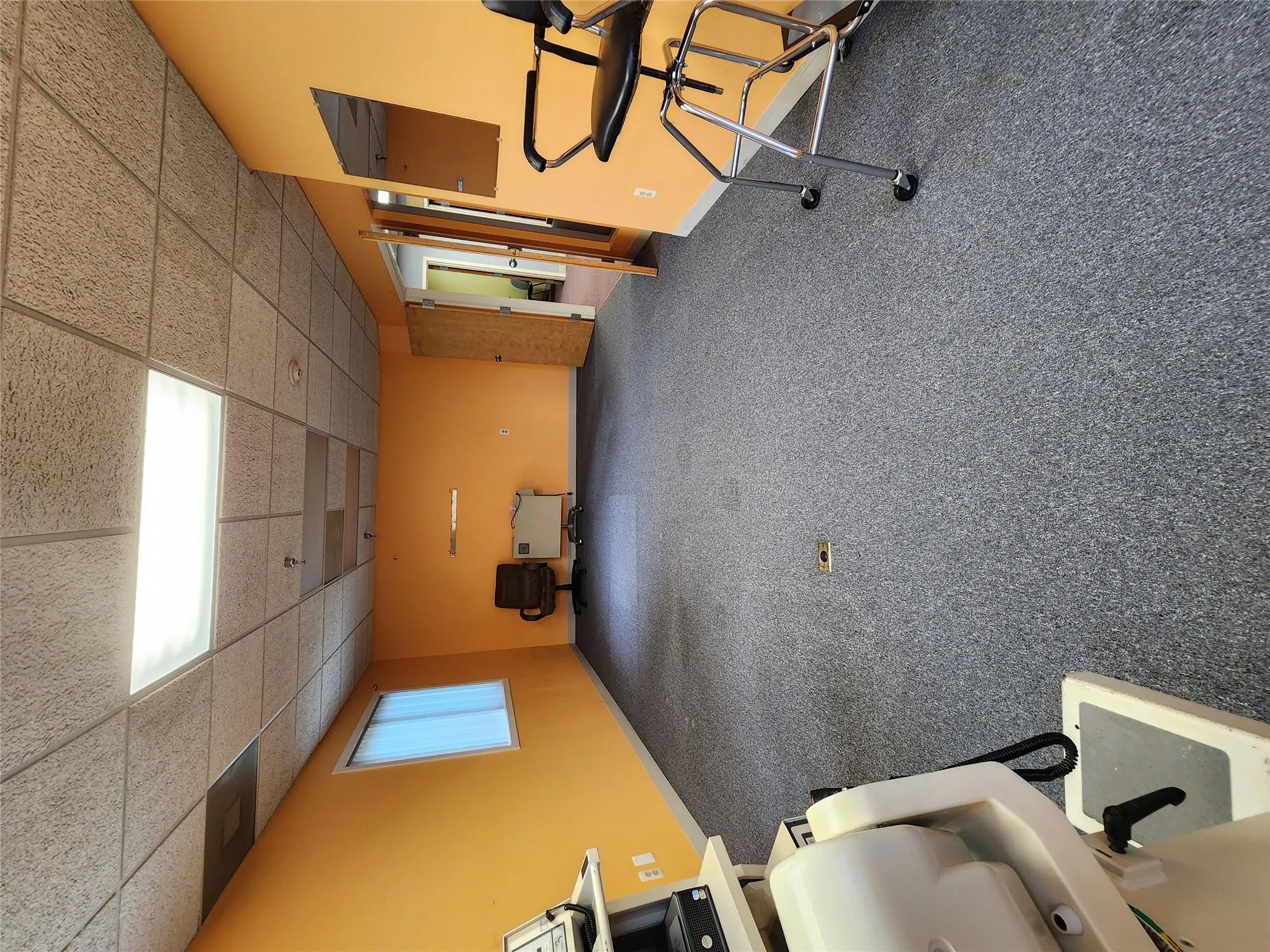 Exercise room with a drop ceiling, baseboards, and carpet flooring Exercise room with a drop ceiling, baseboards, and carpet flooring