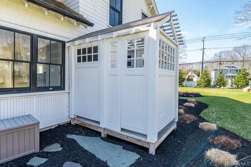 View of exterior entry featuring a yard View of exterior entry featuring a yard
