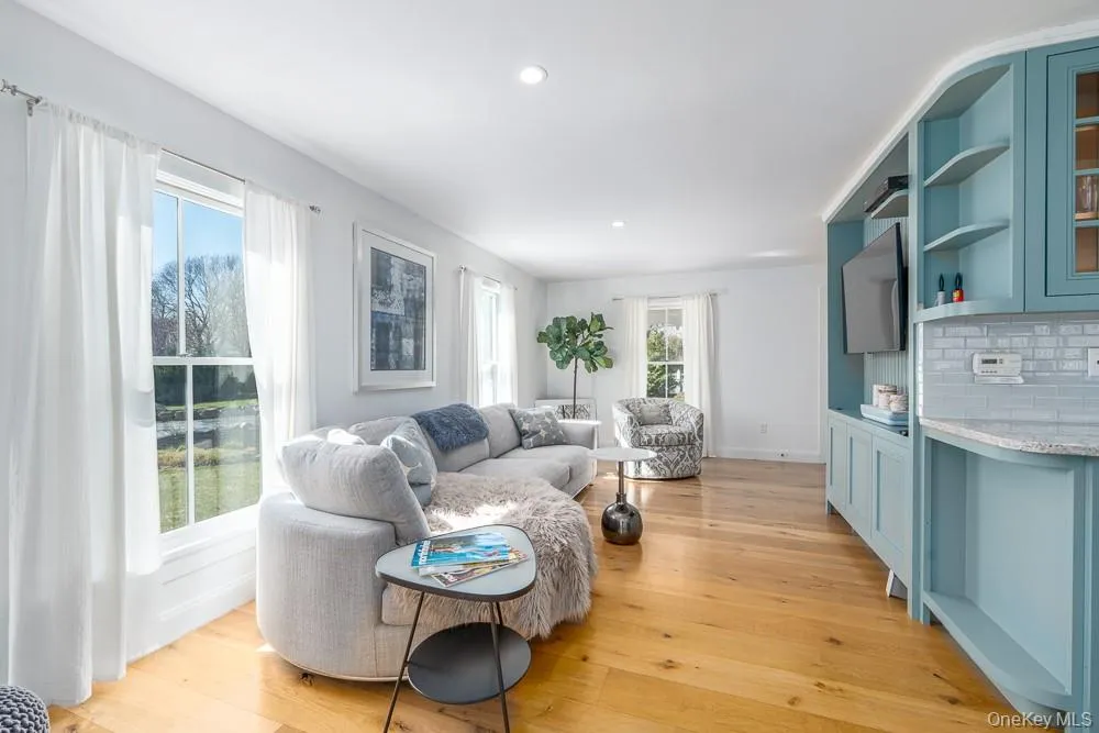 Living room featuring light wood finished floors, recessed lighting, and baseboards Living room featuring light wood finished floors, recessed lighting, and baseboards