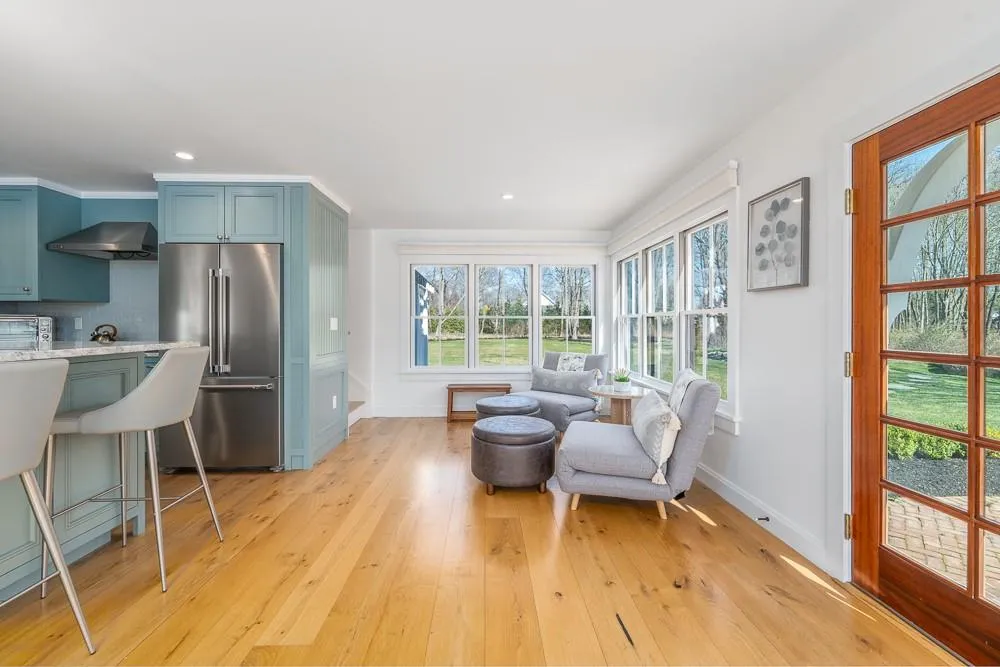 Living area featuring baseboards, light wood-type flooring, and recessed lighting Living area featuring baseboards, light wood-type flooring, and recessed lighting