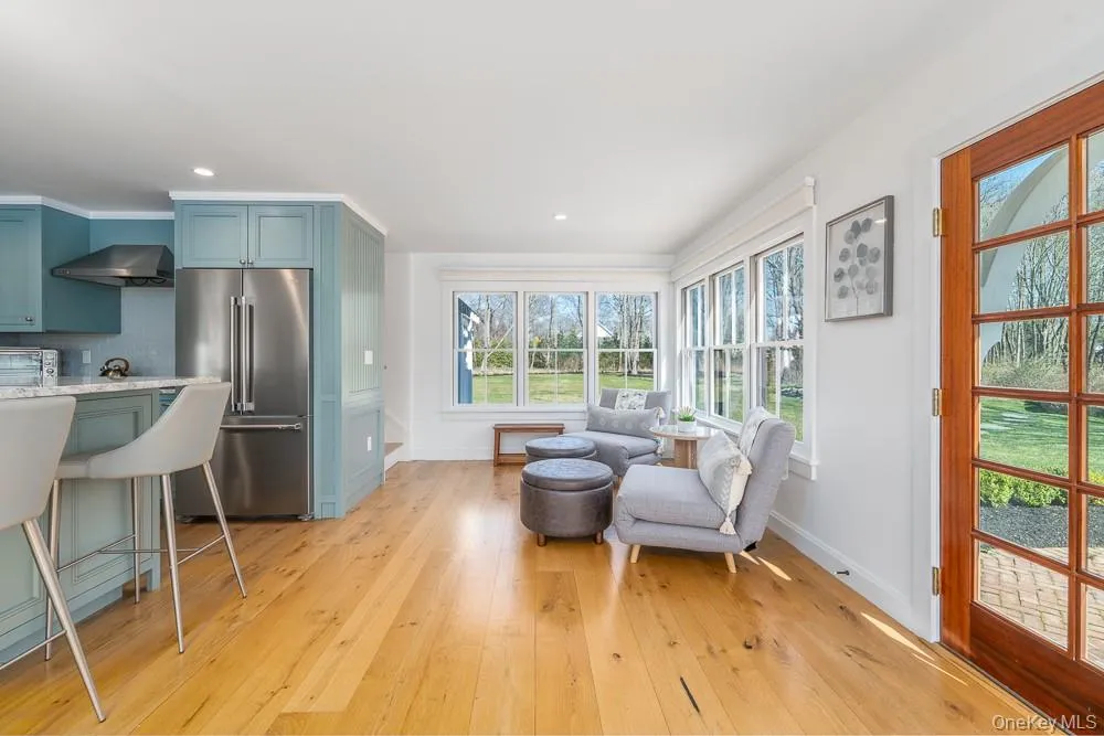 Living area featuring baseboards, light wood-type flooring, and recessed lighting Living area featuring baseboards, light wood-type flooring, and recessed lighting