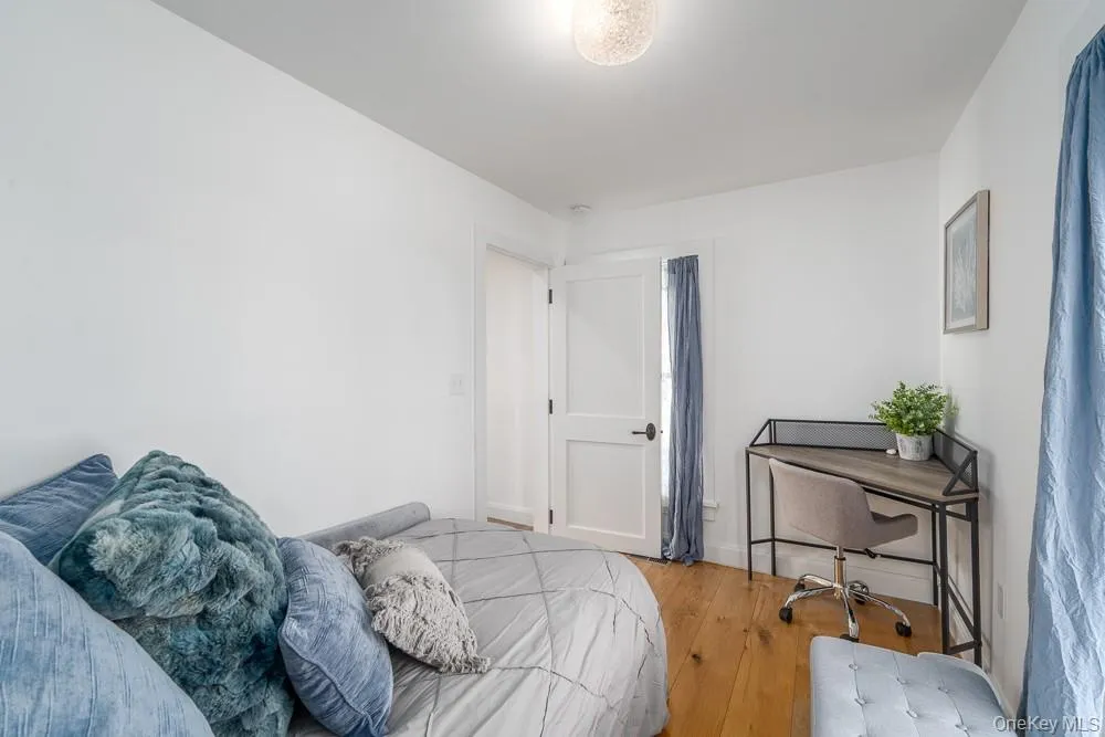 Bedroom featuring wood finished floors Bedroom featuring wood finished floors
