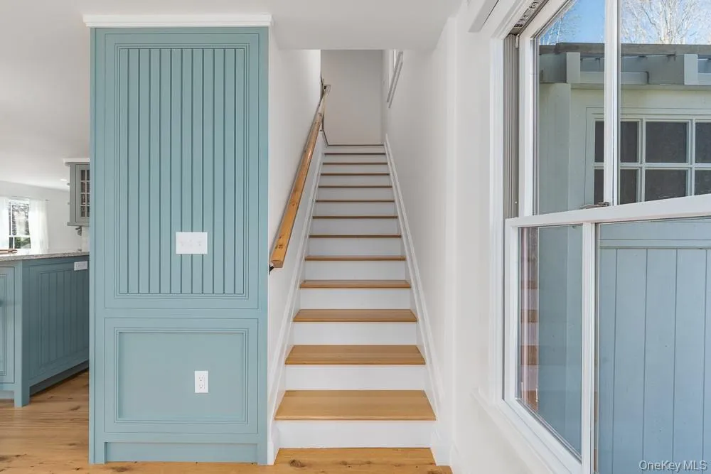 Stairway featuring wood finished floors Stairway featuring wood finished floors