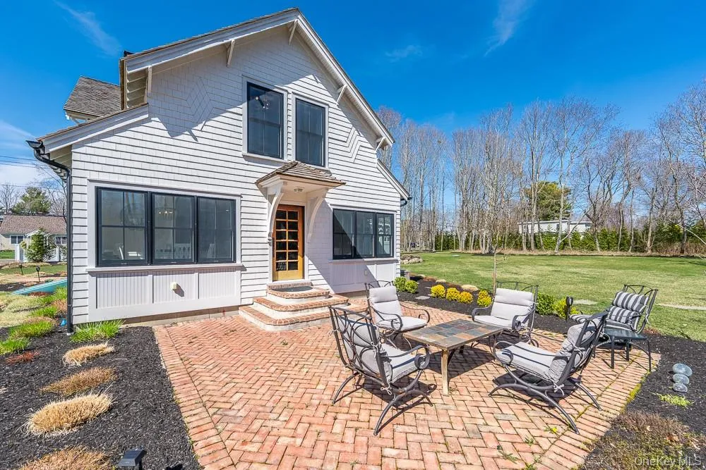 Back of house with a patio, a lawn, and entry steps Back of house with a patio, a lawn, and entry steps