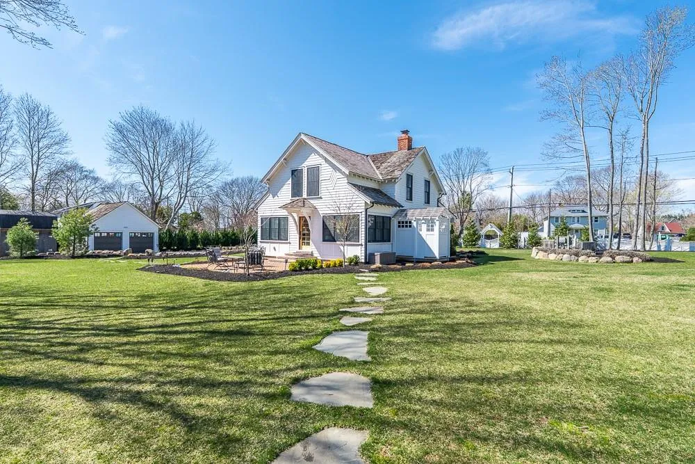 View of front of home with a chimney and a front lawn View of front of home with a chimney and a front lawn
