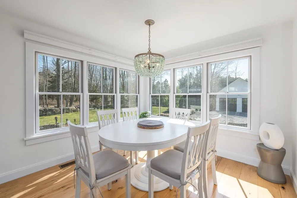 Dining space with a chandelier, baseboards, healthy amount of natural light, and light wood-style floors Dining space with a chandelier, baseboards, healthy amount of natural light, and light wood-style floors
