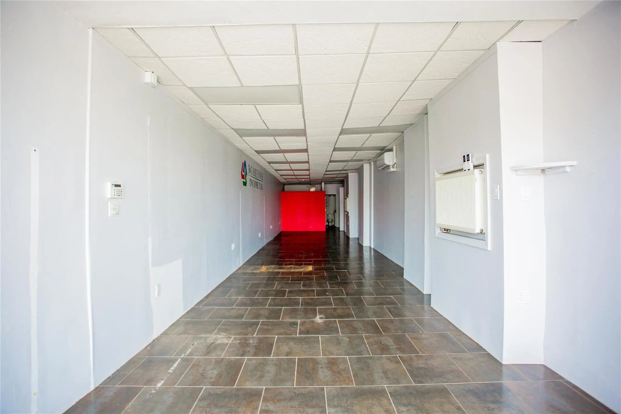 Corridor featuring a paneled ceiling Corridor featuring a paneled ceiling