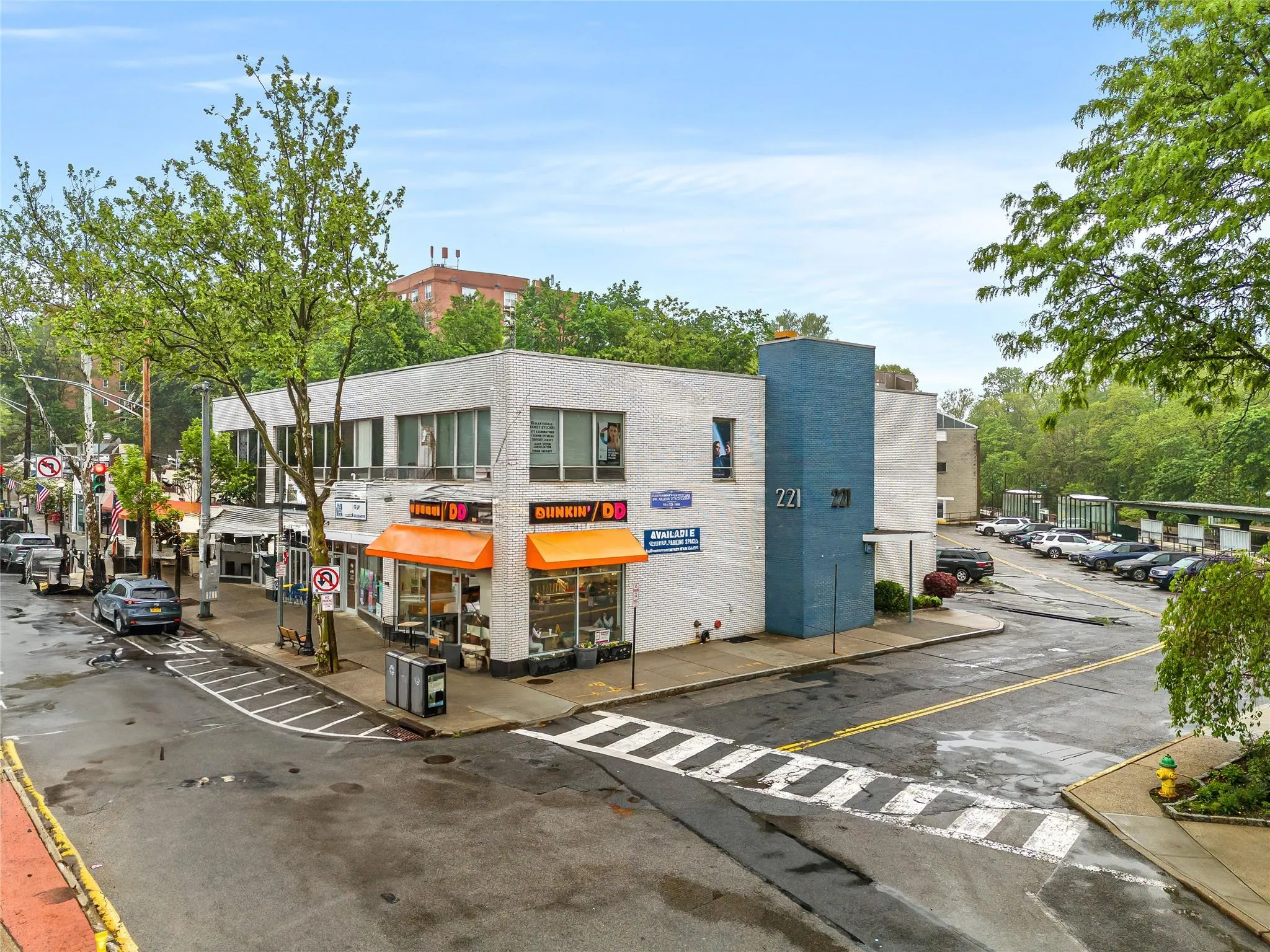 View of building exterior featuring uncovered parking View of building exterior featuring uncovered parking