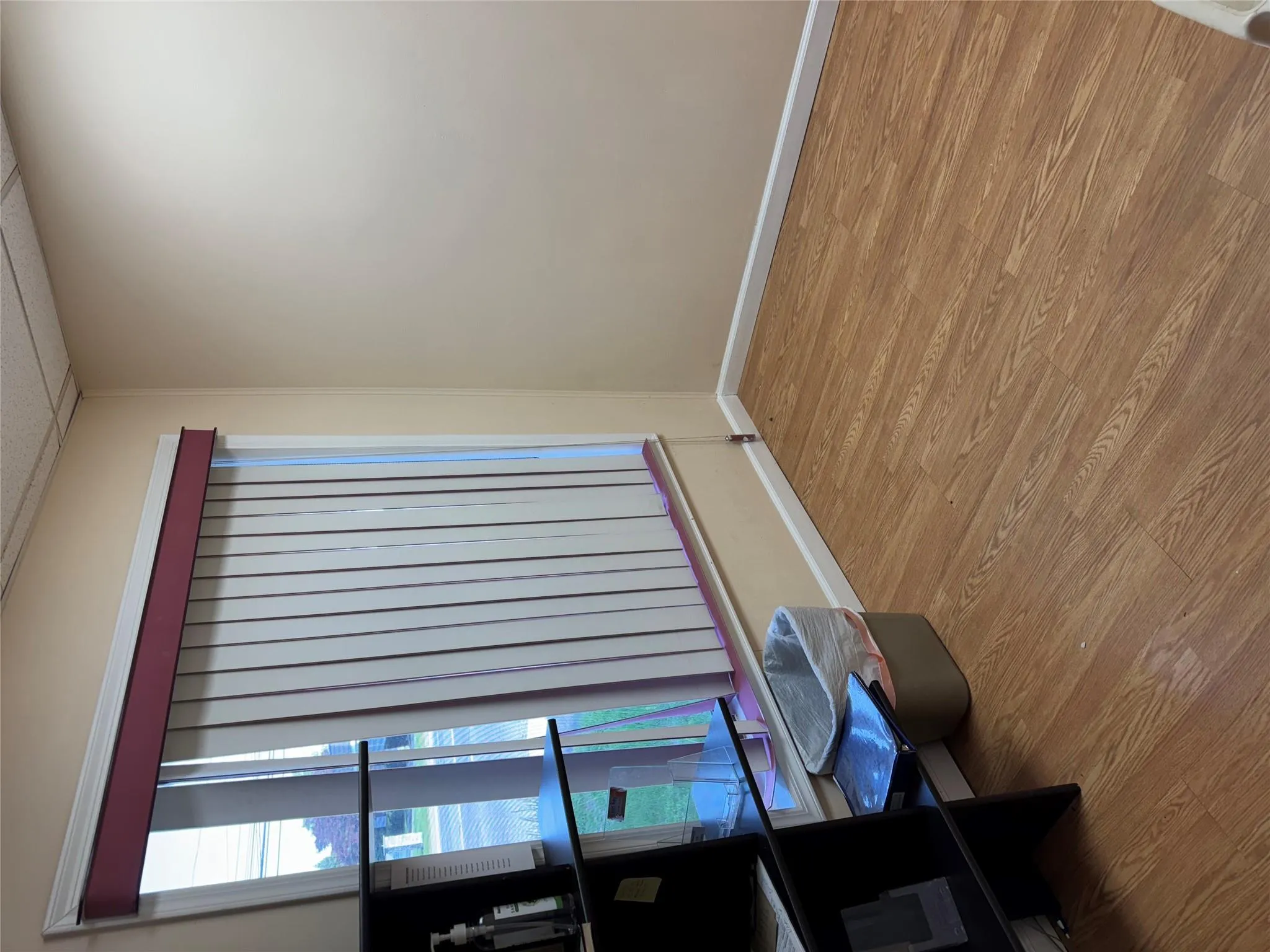 Spare room featuring wood finished floors, baseboards, and a paneled ceiling Spare room featuring wood finished floors, baseboards, and a paneled ceiling