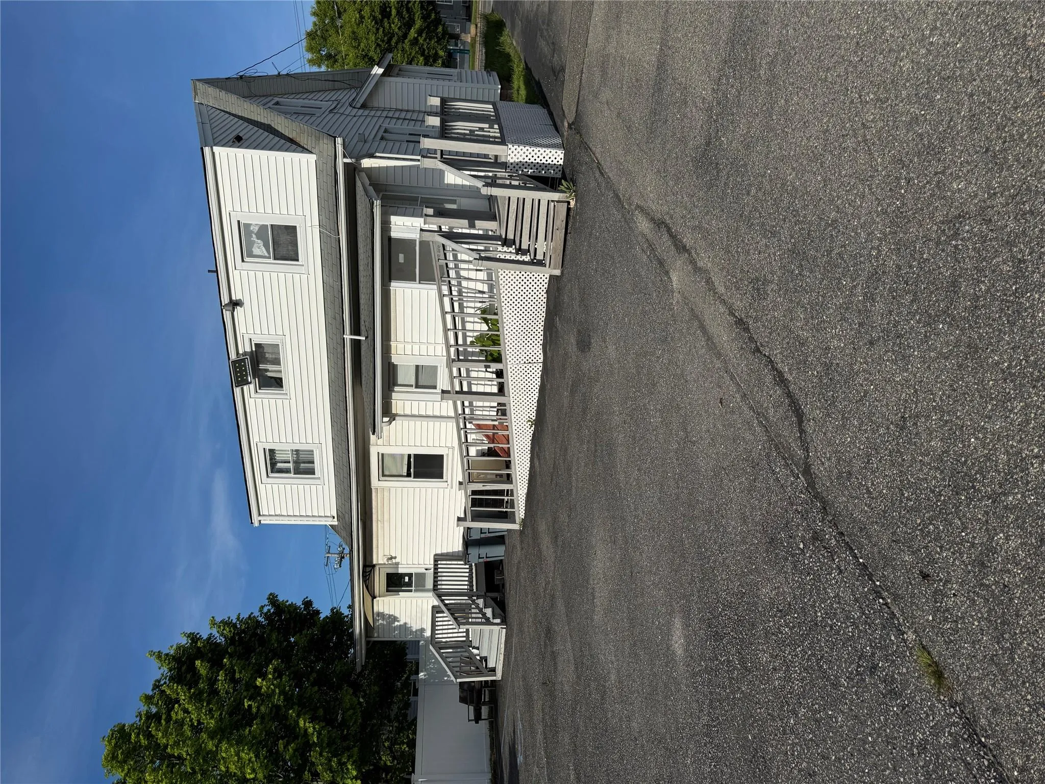 Rear view of house featuring a shingled roof Rear view of house featuring a shingled roof