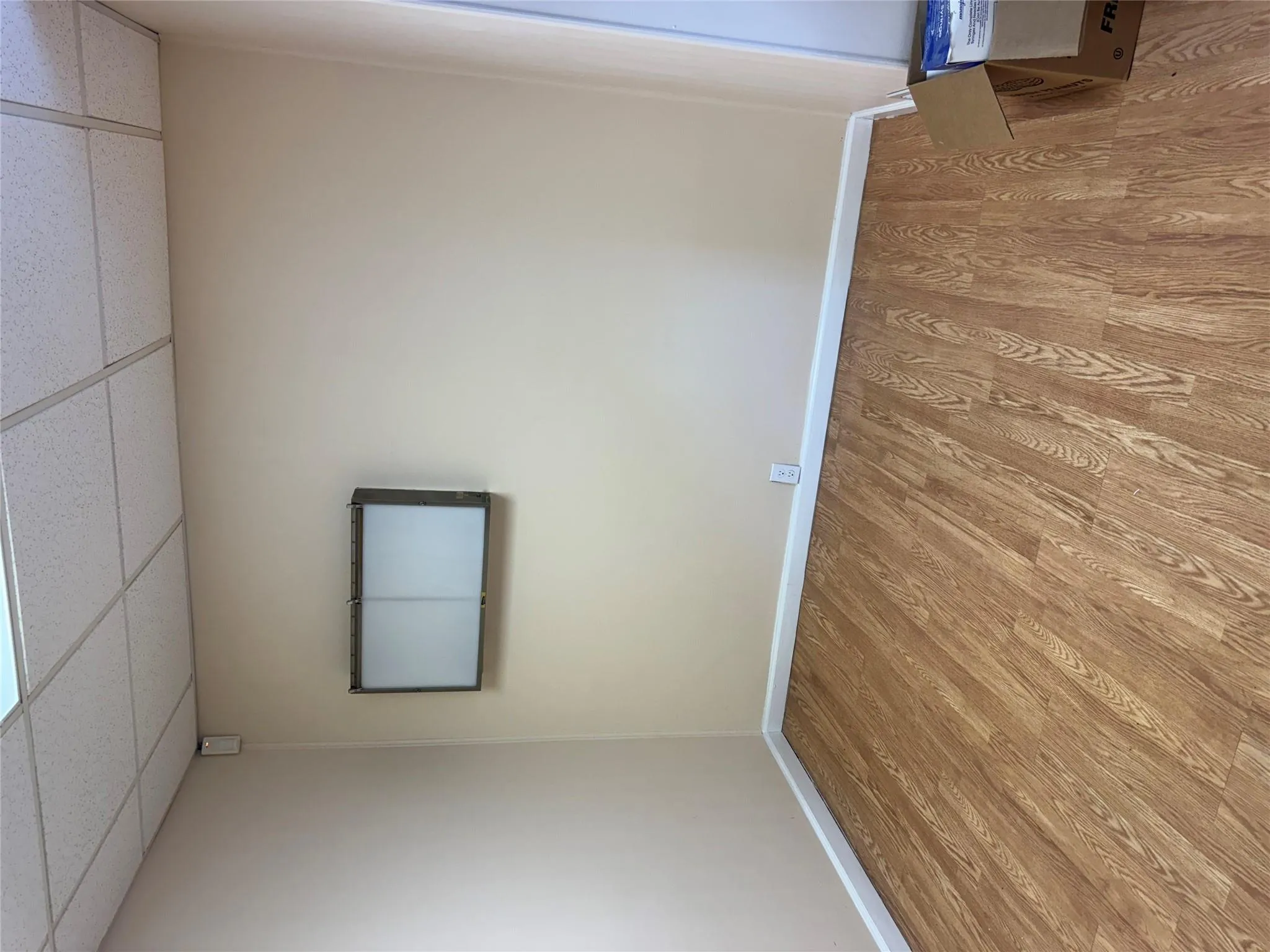 Unfurnished room featuring a drop ceiling, baseboards, and light wood-type flooring Unfurnished room featuring a drop ceiling, baseboards, and light wood-type flooring